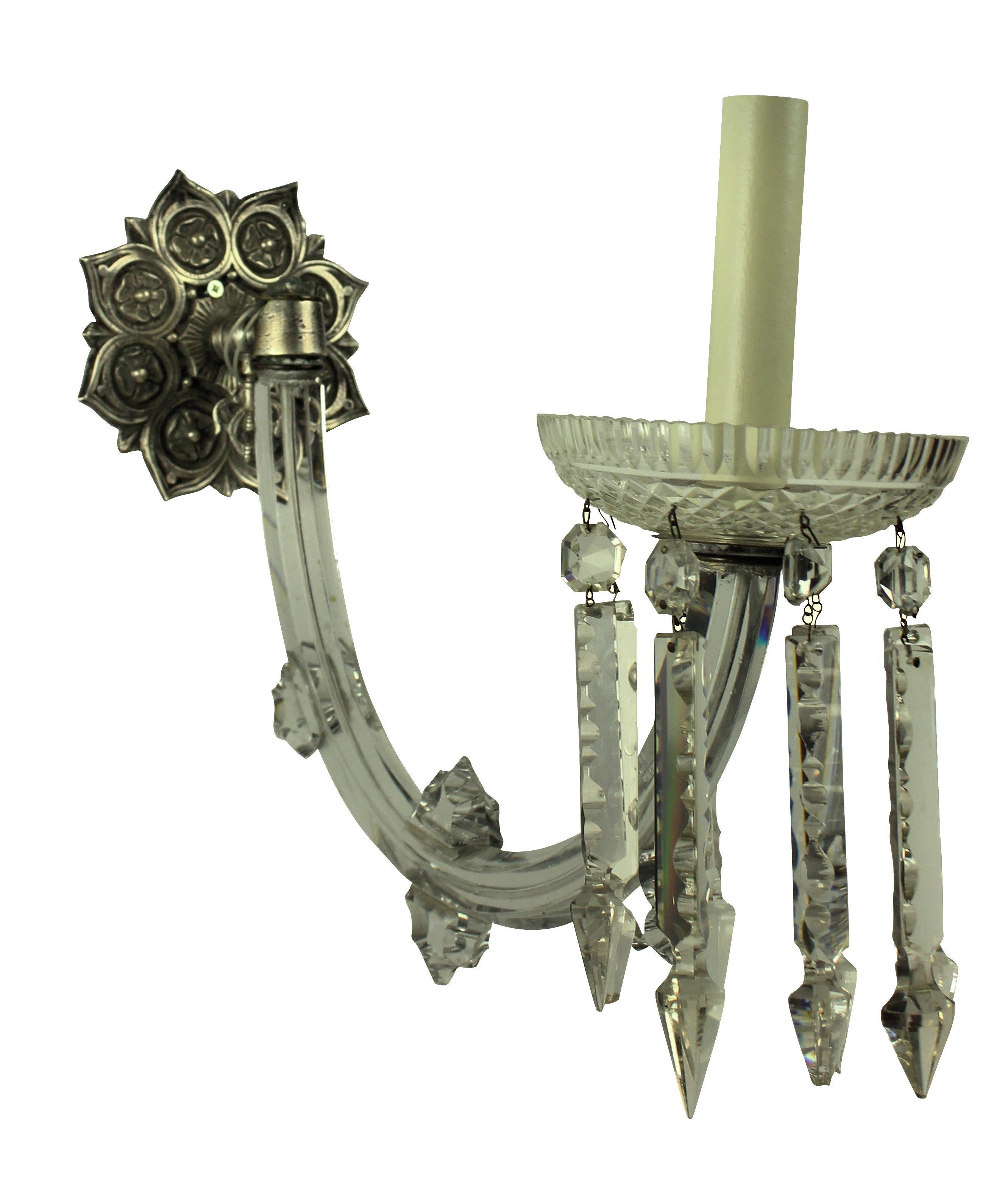 A pair of good quality English single arm sconces, with large up-swept handcut-glass arms with decorative glass finials and a finely cut dish with pendants. The metal work of silvered bronze.