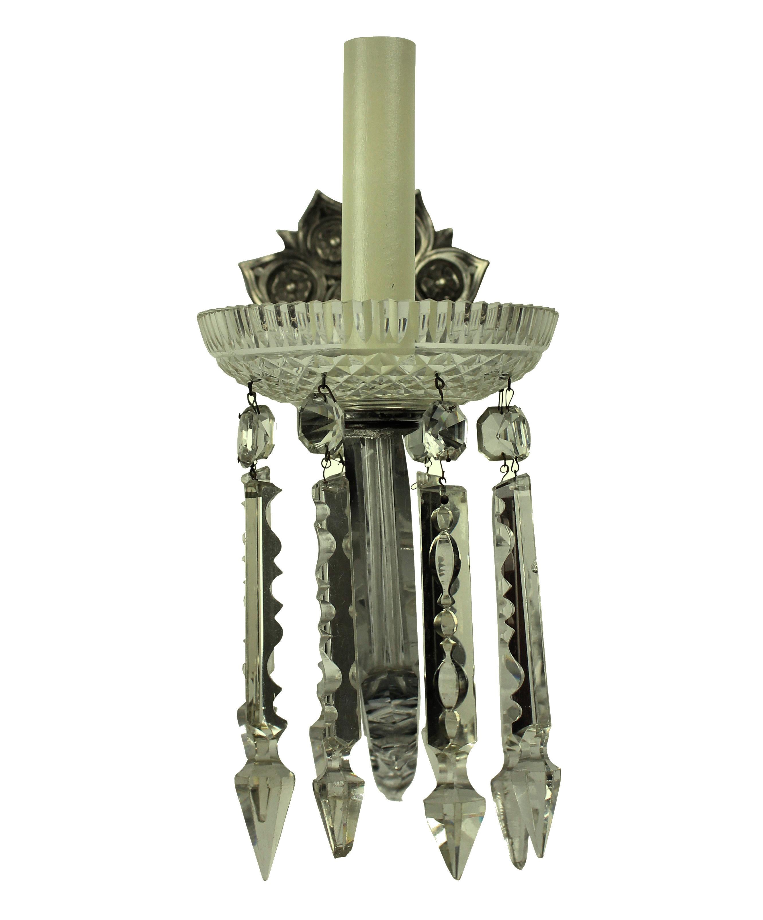 A pair of good quality English single arm sconces, with large up-swept handcut glass arms with decorative glass finials and a finely cut dish with pendants. The metal work of silvered bronze.