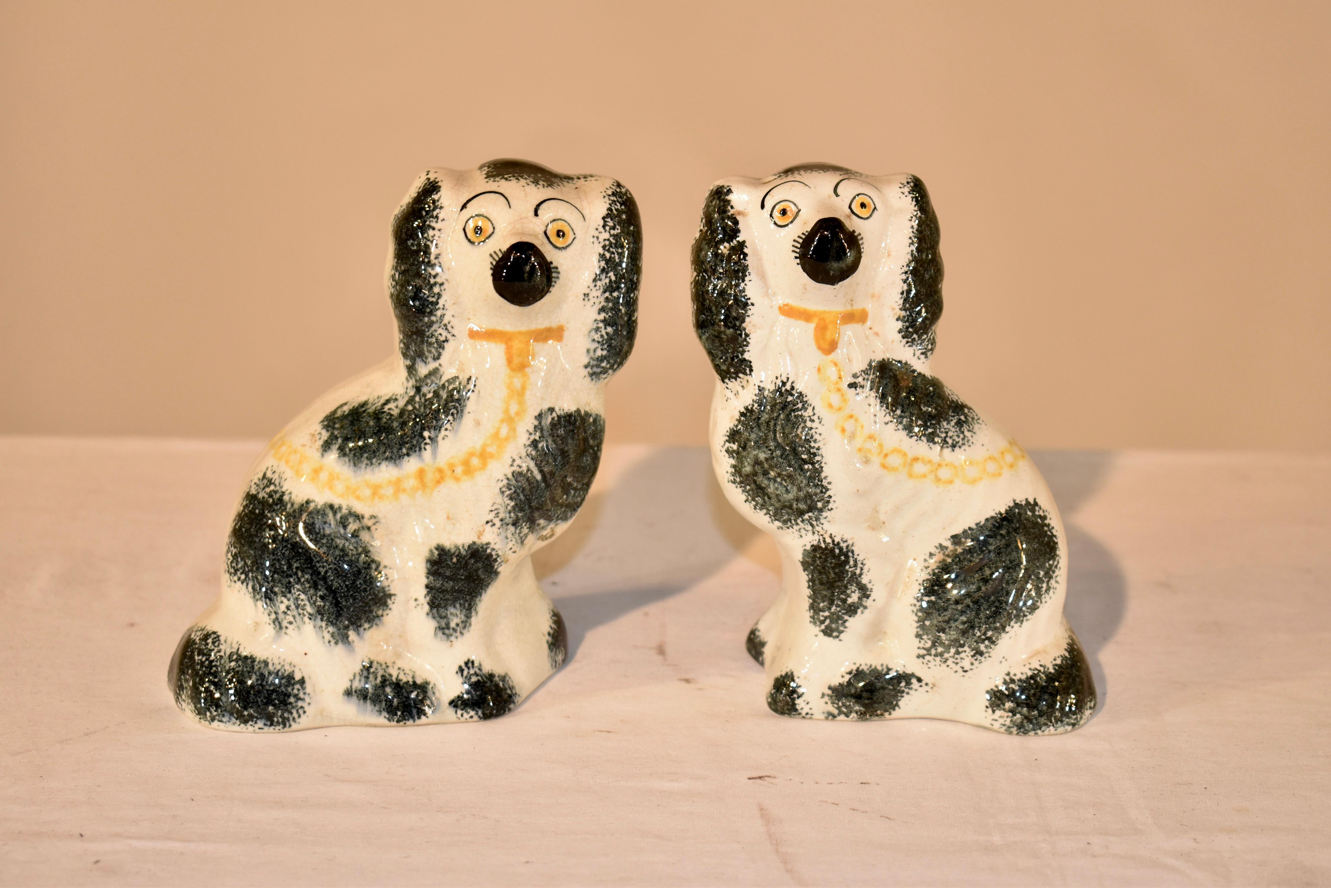 Pair of lovely 19th century English Staffordshire small spaniels.  The faces are  adorable on this pair, and they are sponge painted decorated, which are unusual and interesting.  These will be a great addition to any collection.