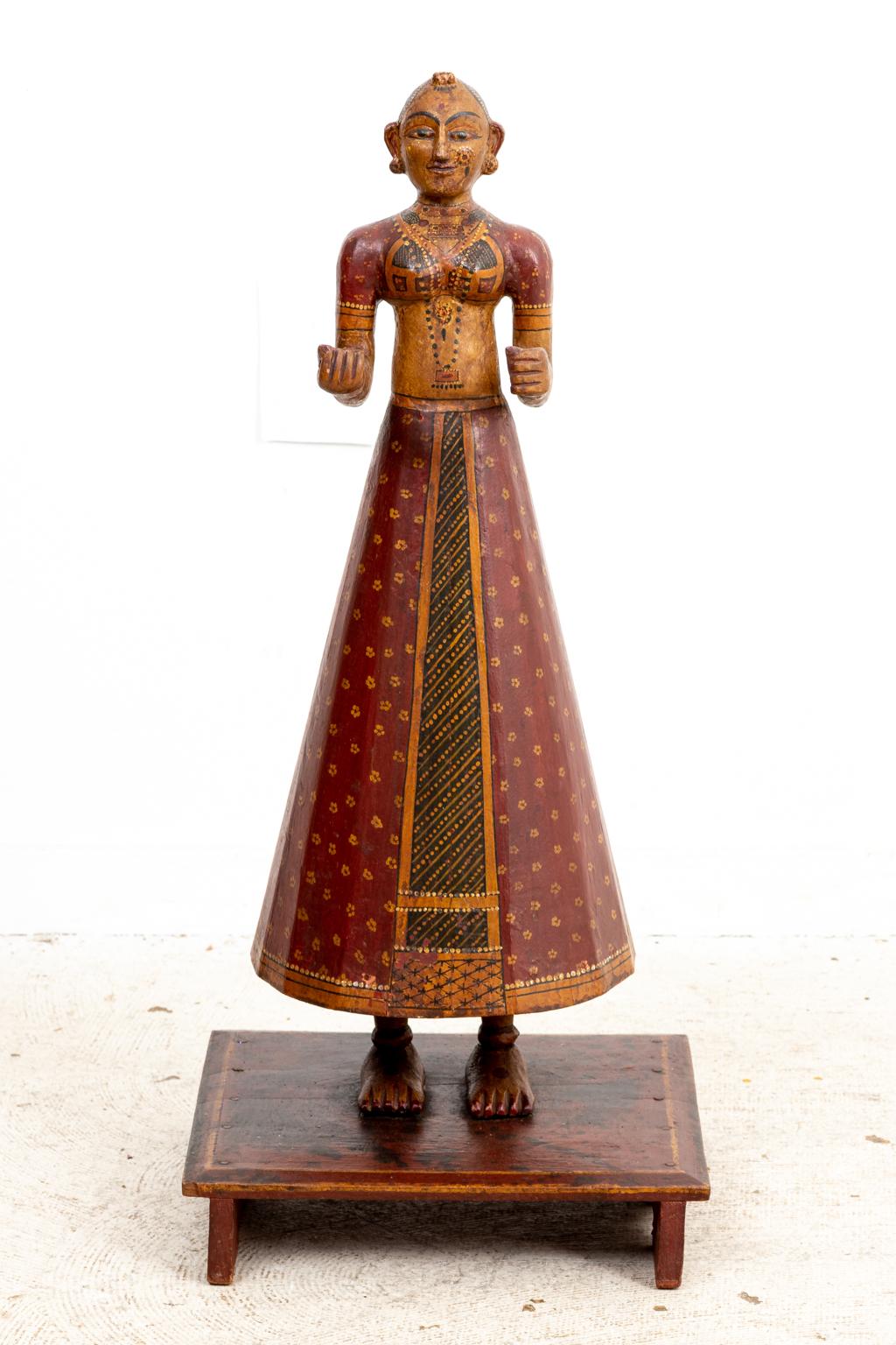 Circa mid-19th century Pair of male and female painted wood figures composed of polychrome painted wood in highly detailed dress. The figures were made during the second half of the 19th century in southern India.