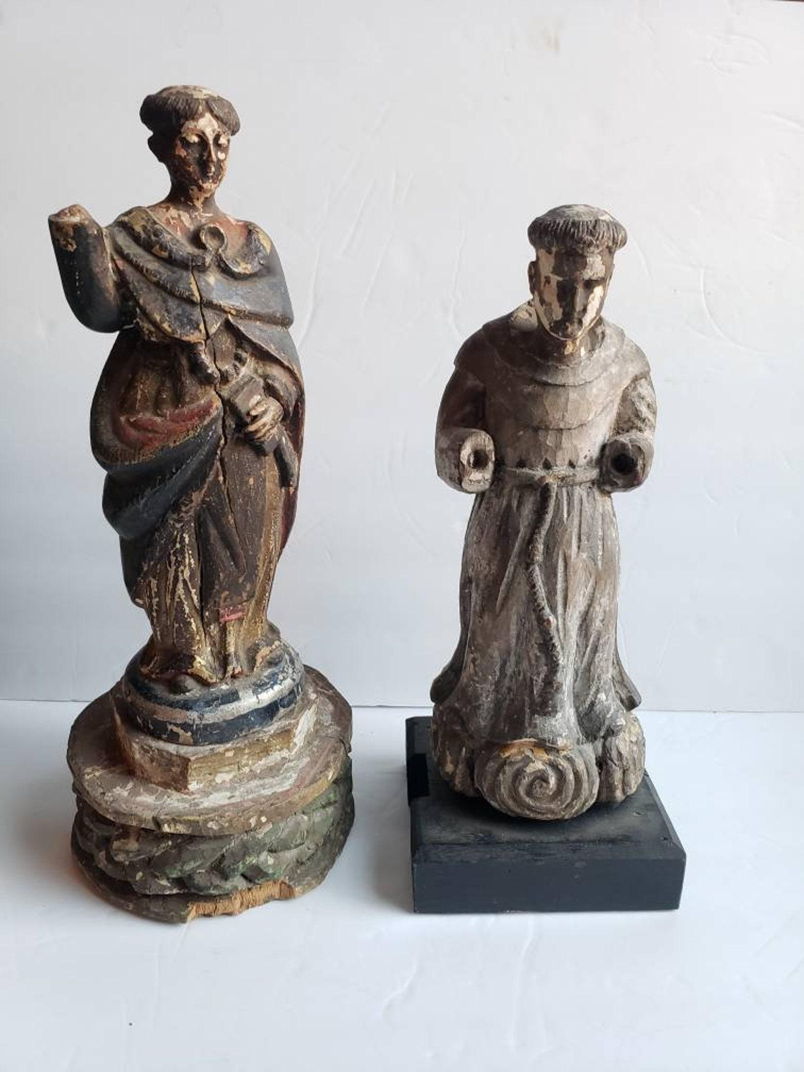 A pair of antique Spanish Colonial Santos church altar figures - religious folk art statue - sculpture. Born in the 19th century, hand carved and polychrome painted wood and gesso, each depicting ecclesiastical figures in Franciscan monk habit. One