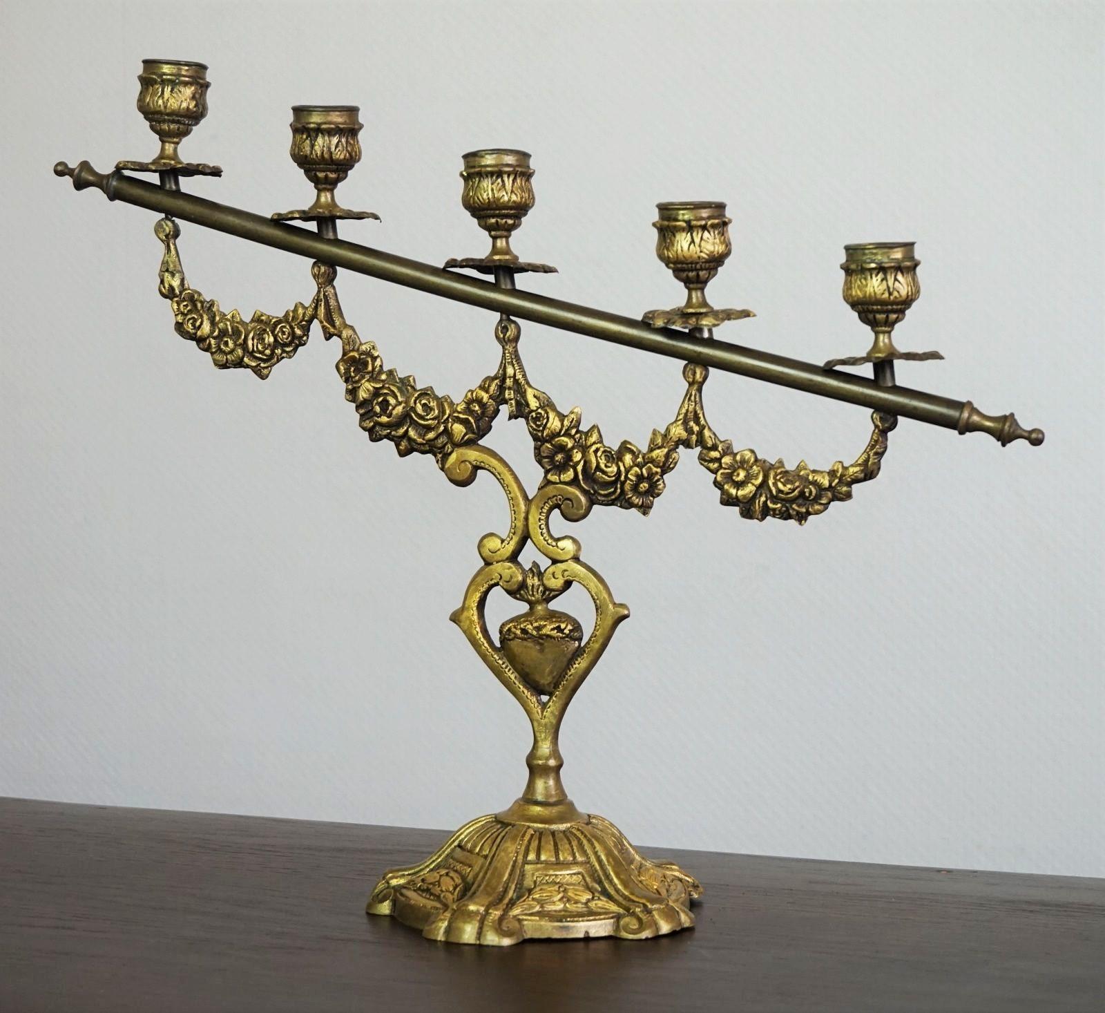 A rare pair of fire-gilded bronze five-light altar candelabra decorated with sublime details, Spain, mid-19th century.
Great aged patina to bronze. 
Dimensions:
Height 14.25 inches (36 cm)
Width 16.50 inches (42 cm)
Base diameter 5.12 inches