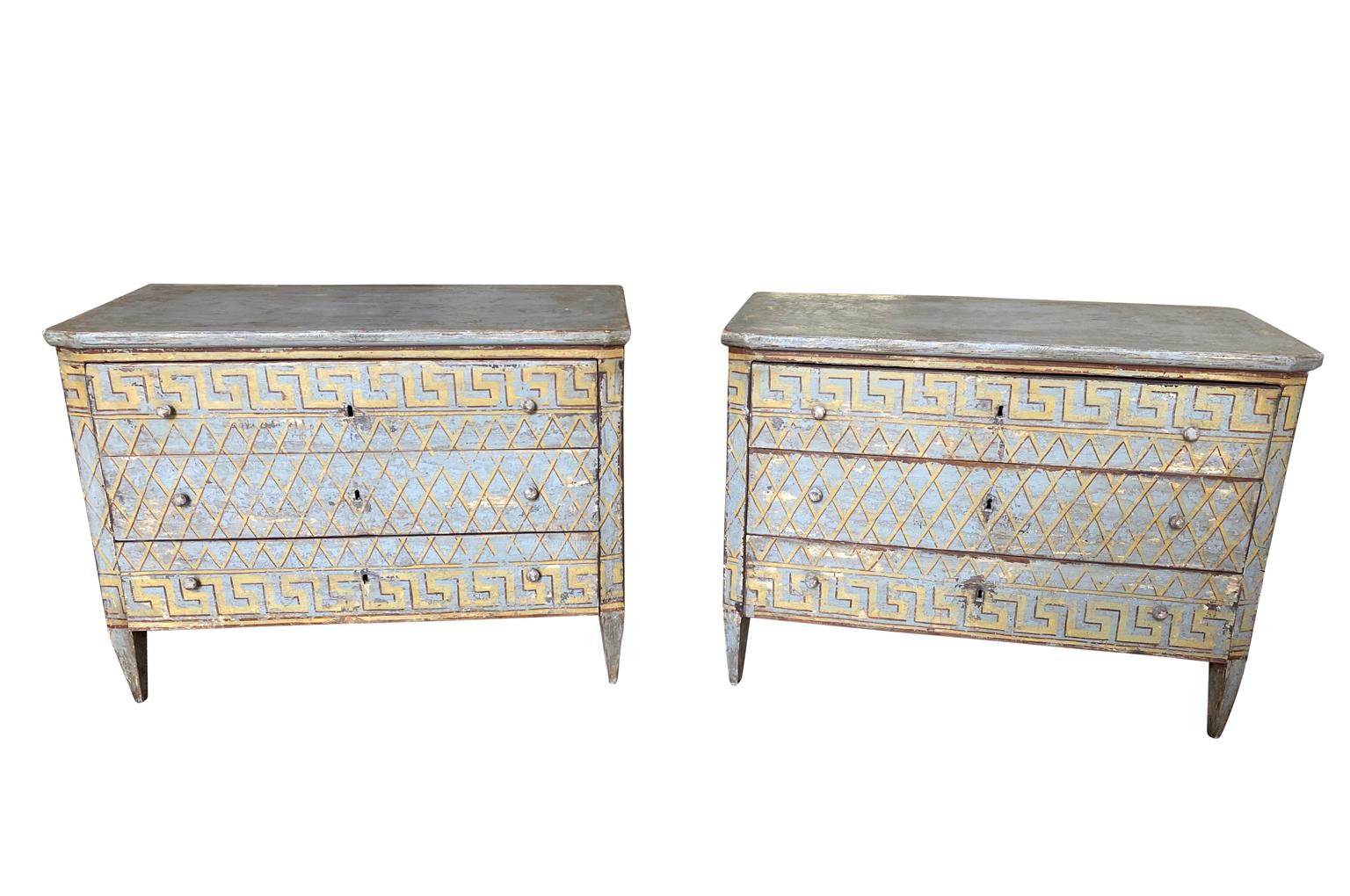 A wonderful pair of later 19th century commodes from the Catalan region of Spain. Soundly constructed from painted wood with three drawers over tapered legs and a lovely Greek Key motif. Terrific as bedside tables or converted into vanities. One