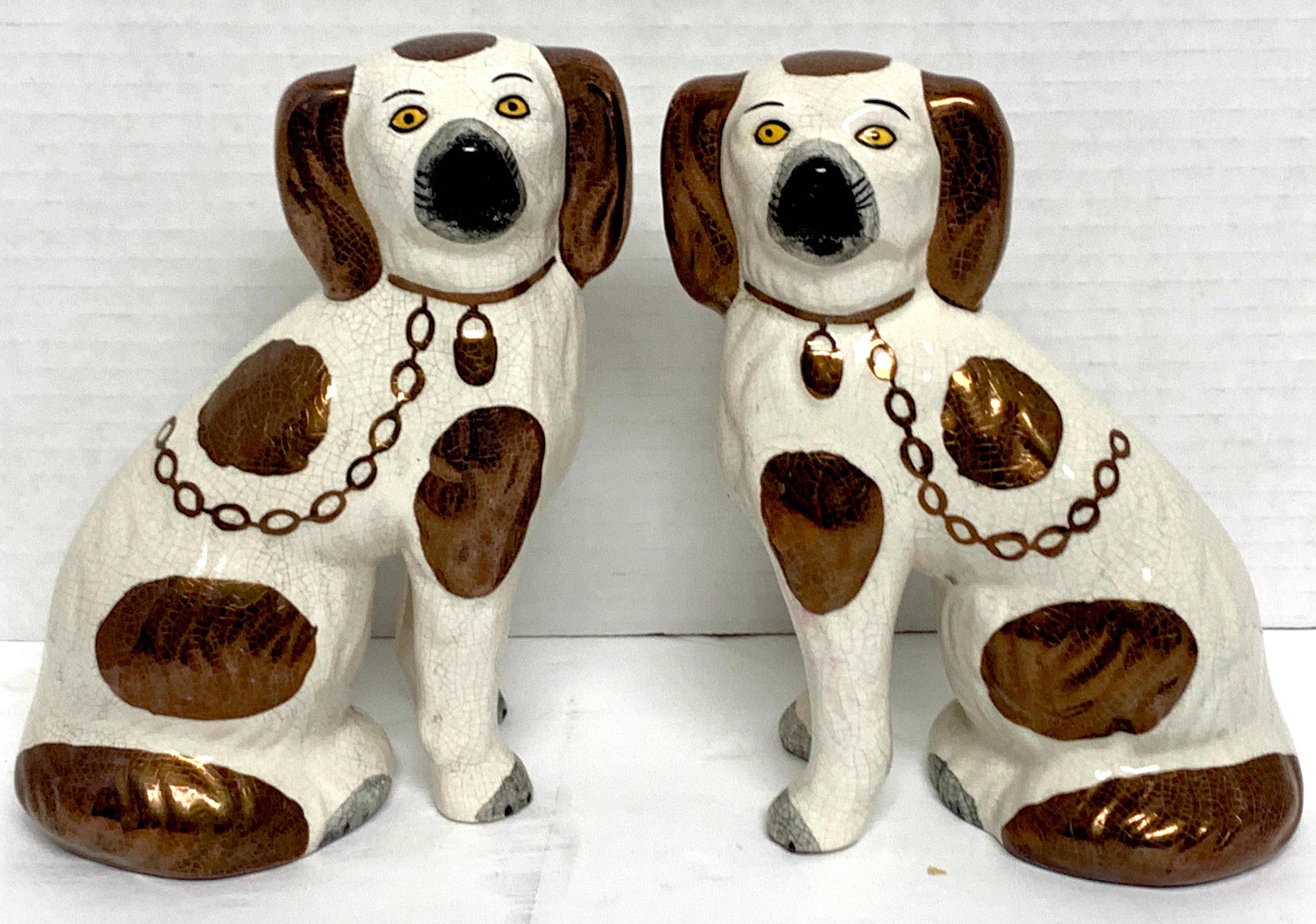 Pair of 19th century Staffordshire diminutive copper luster dogs, facing left and right with chains and padlocks, standing on separated front legs. Unusual size, nicely painted.