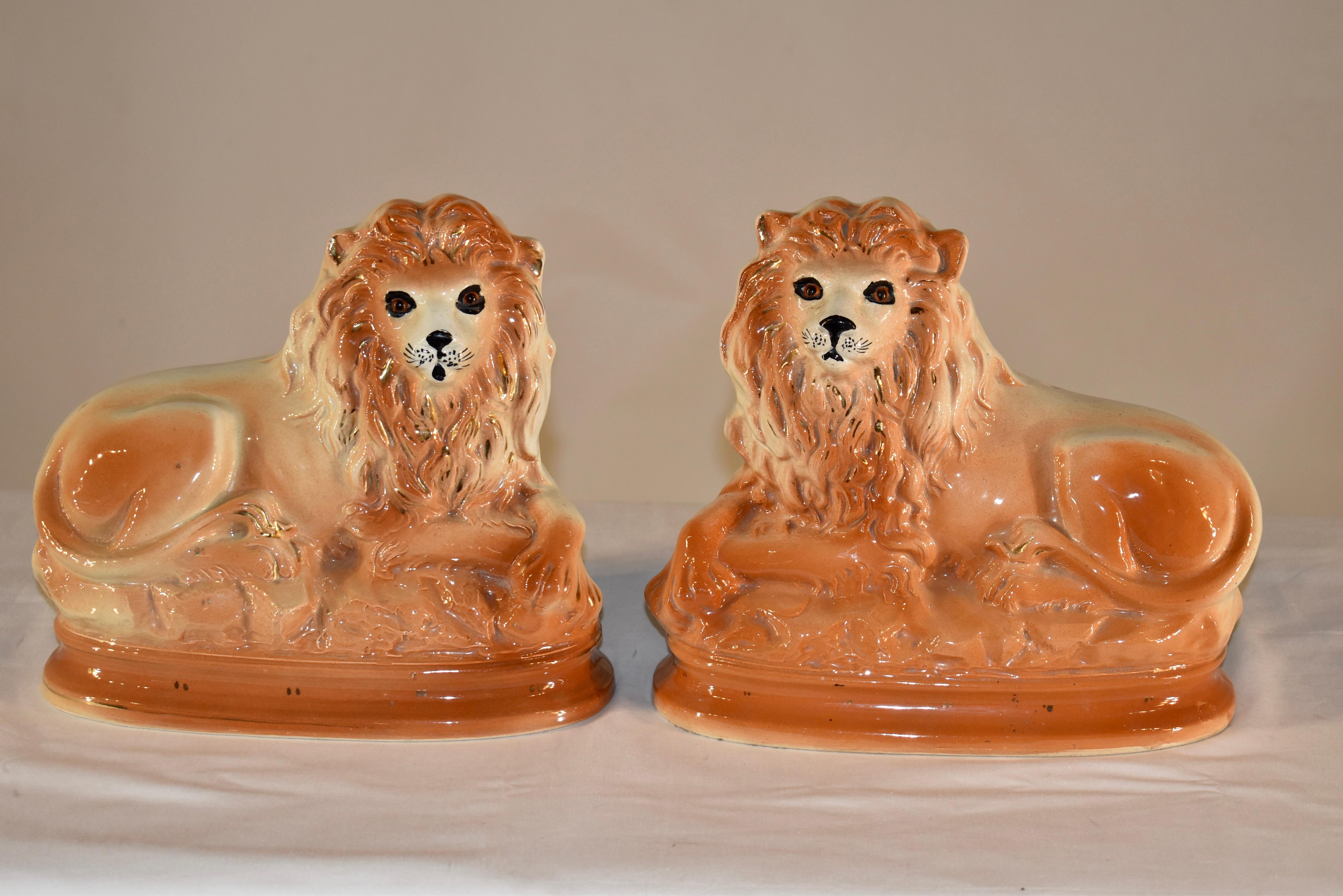 Pair of lovely 19th century ceramic lions made in the Staffordshire region of England.  Their faces are so regal!  They have original glass eyes and wonderful moldings, so their detail is very defined as well.