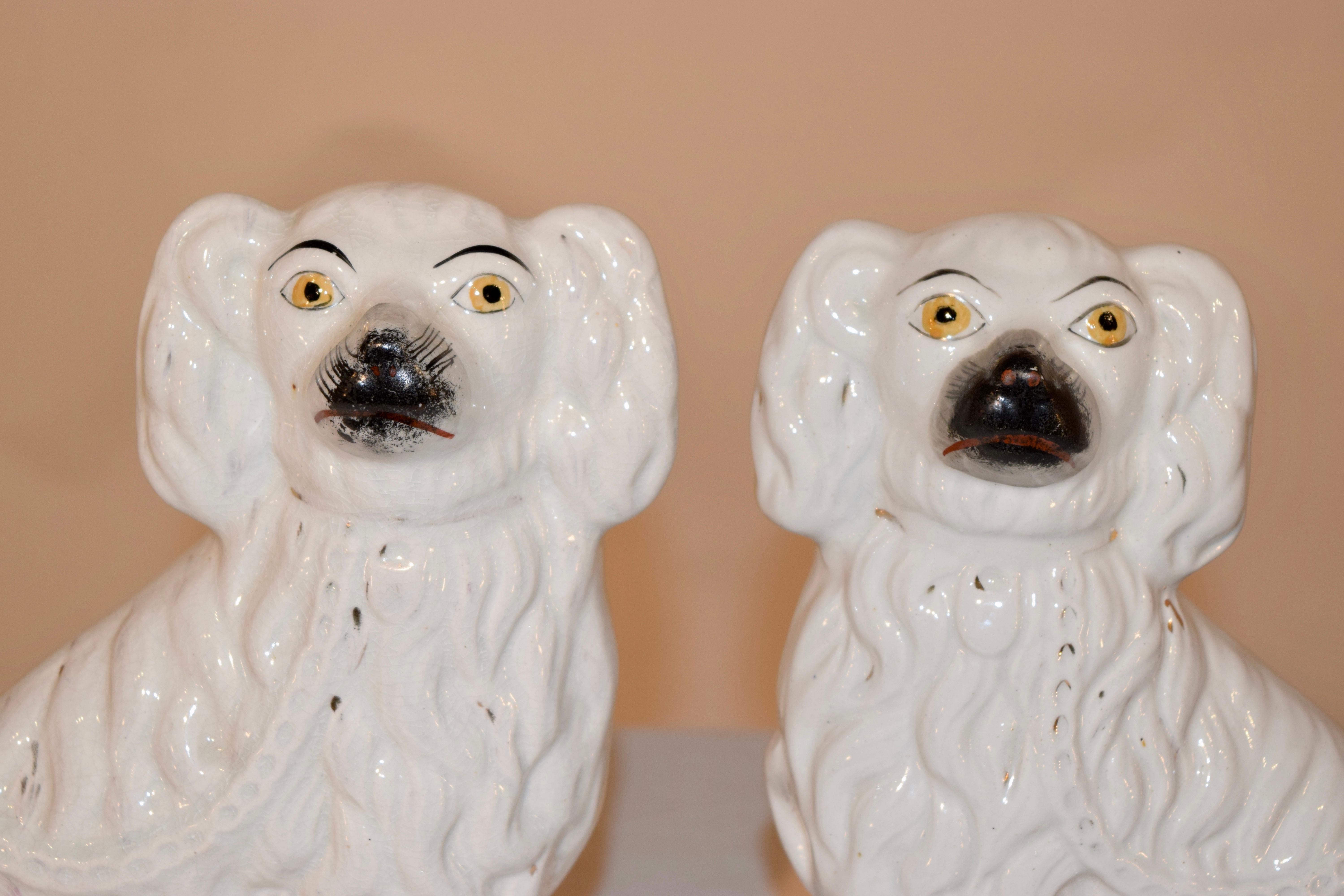 Pair of 19th century Staffordshire spaniels from England in white.