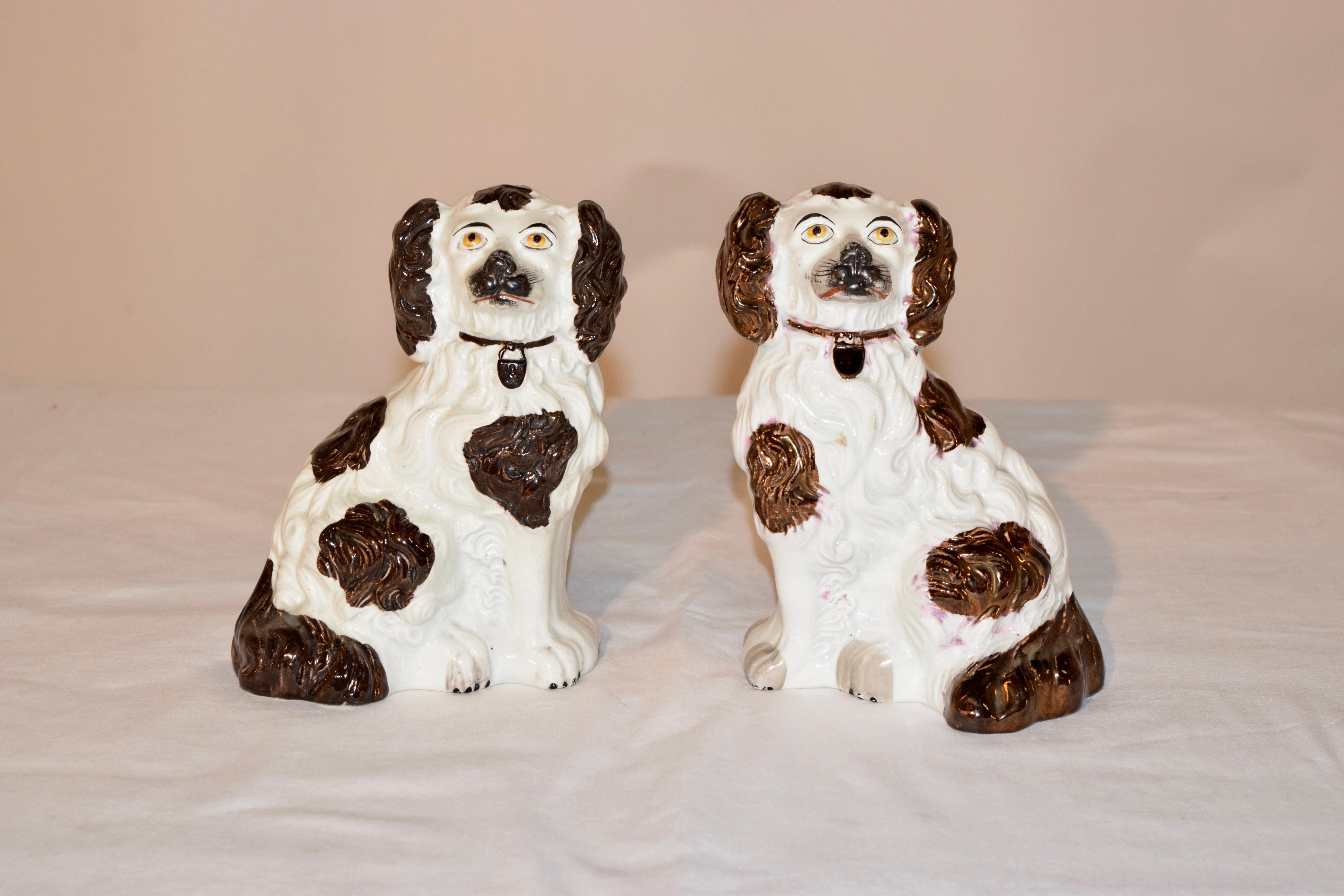 Pair of 19th century Staffordshire spaniels from England made from wonderfully detailed molds, decorated with brown and copper lustre decoration.