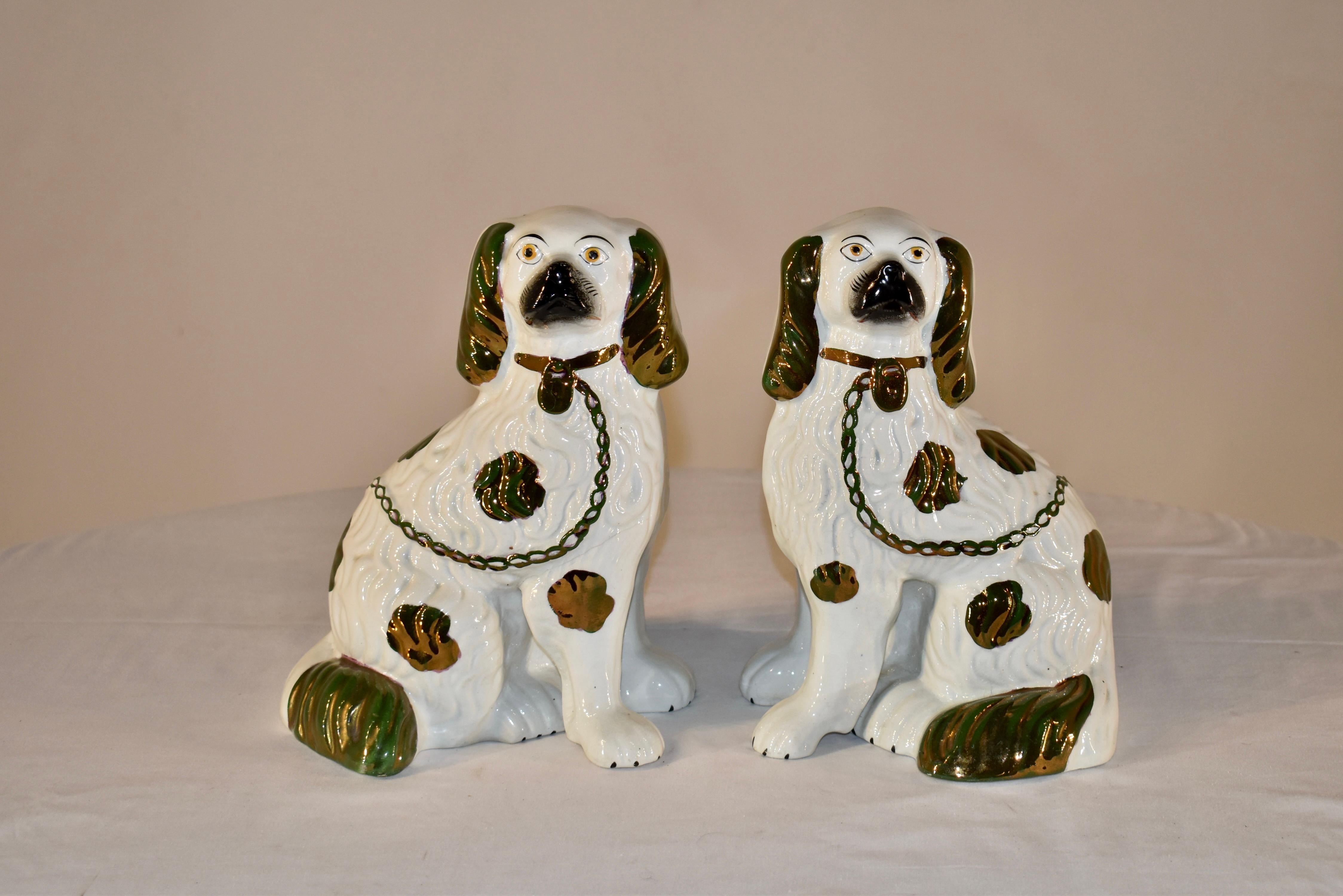 Pair of 19th century Staffordshire spaniels from England. this is a lovely pair, decorated in copper lustre painting and having separated front feet, which is more unusual and harder to find.