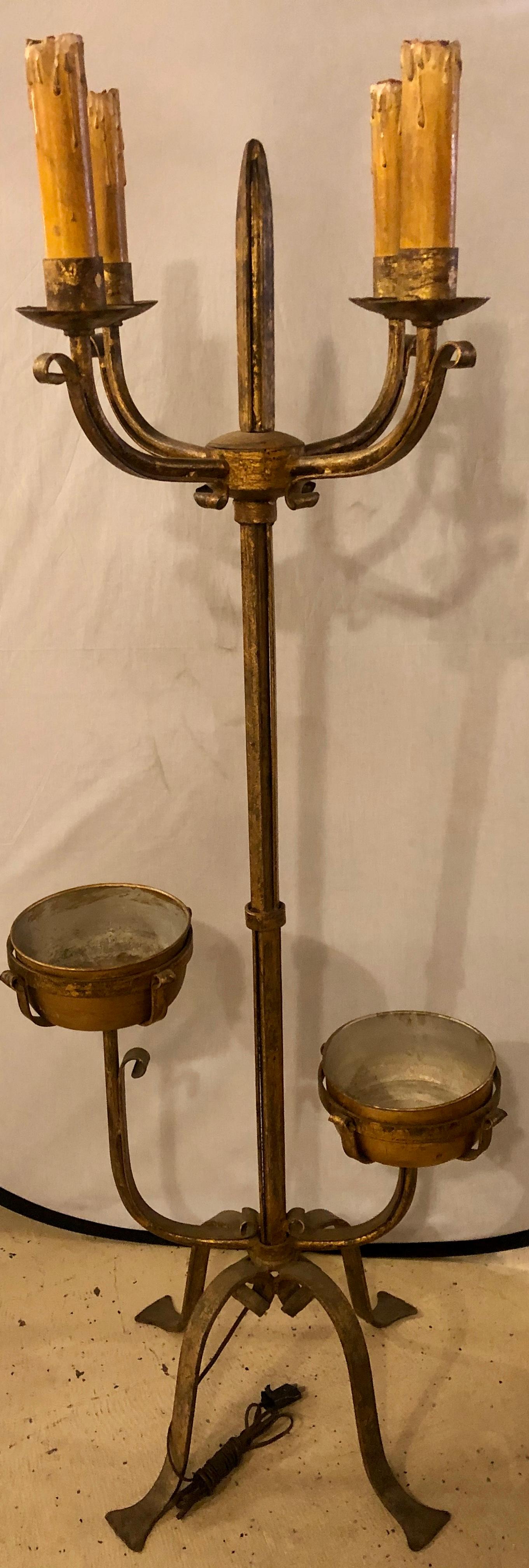 Pair of 19th century standing candelabra lamps. Gilt metal industrial candelabra standing lights. Gothic in nature of gilt metal these spectacular four light standing tall lamps have strong heave metal frames terminating in a spear from standing on