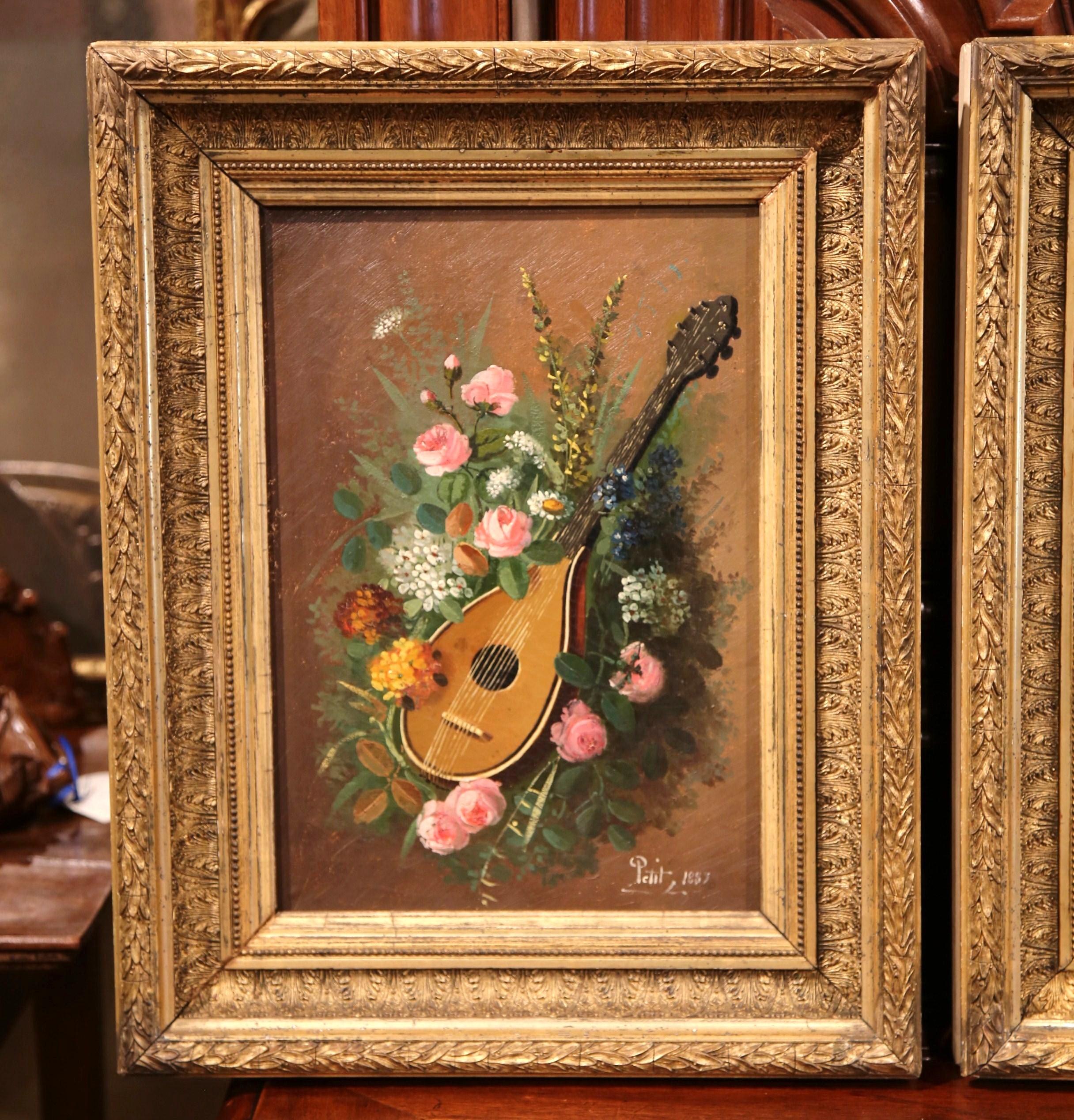 These antique oil on canvas paintings were created in France, circa 1889; set in the original carved gilt frame, each canvas depicts a still life composition; one with flower bouquet and a mandolin, and paint brushes, floral composition and palette