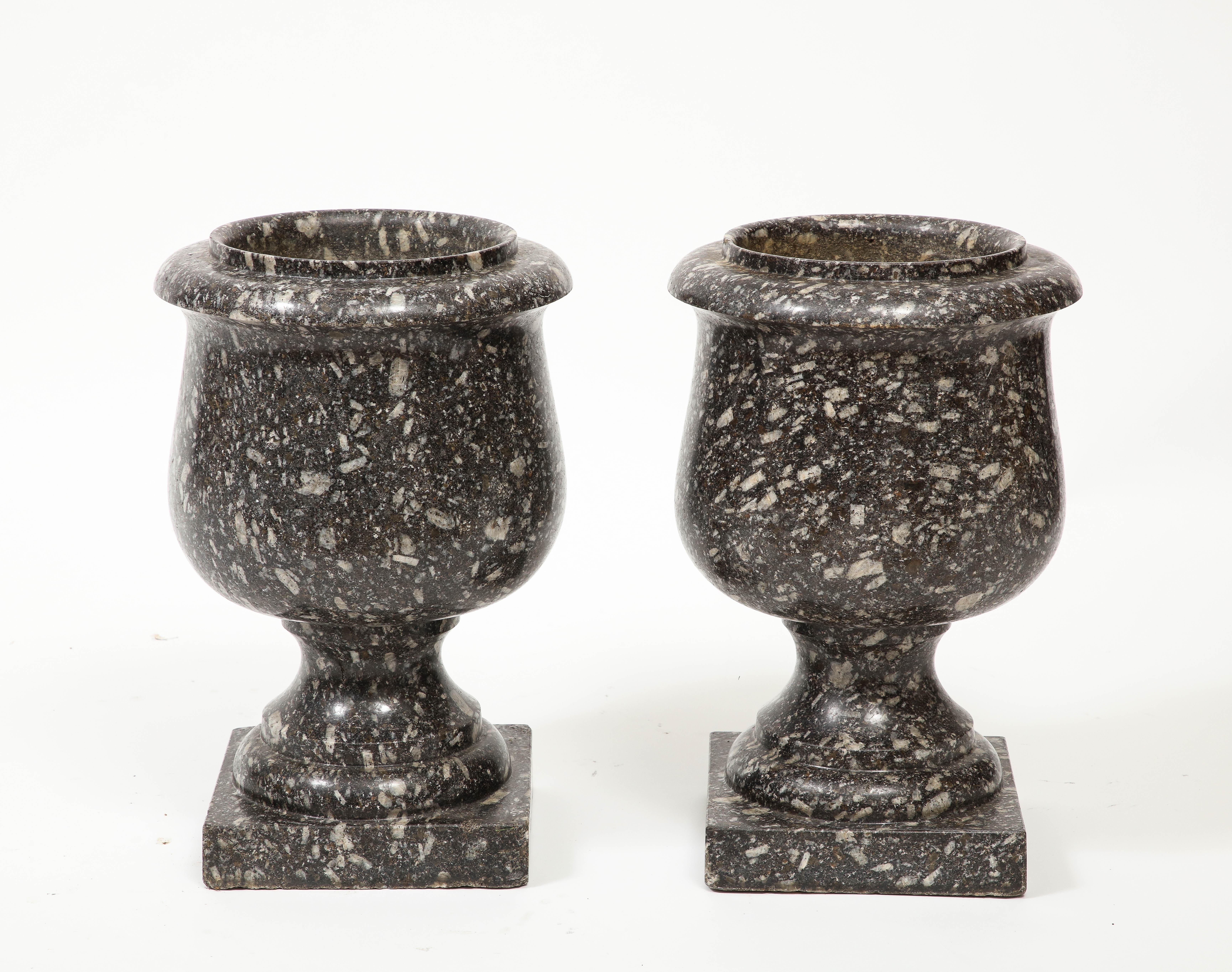 Pair of 19th Century carved stone urns, cup shaped vessel sits upon a stone square base. 

base 7.25