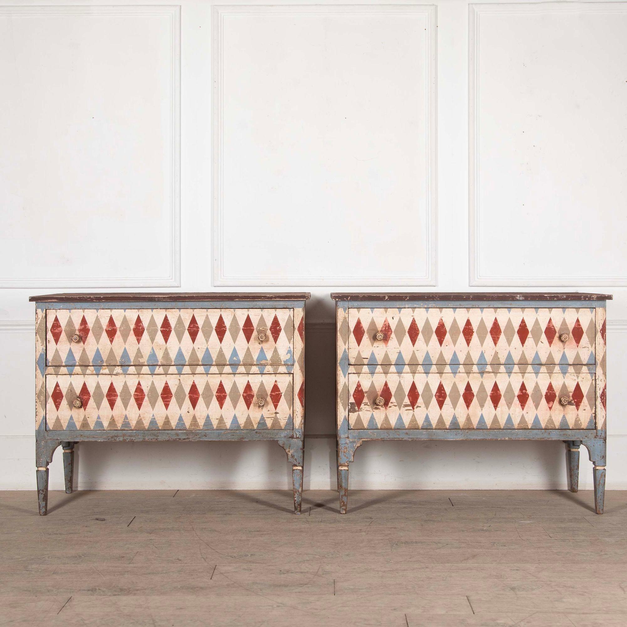 Pair of 19th century style continental commodes.
In a fabulous red, blue and white harlequin design each featuring two drawers and standing on simple tapering legs.