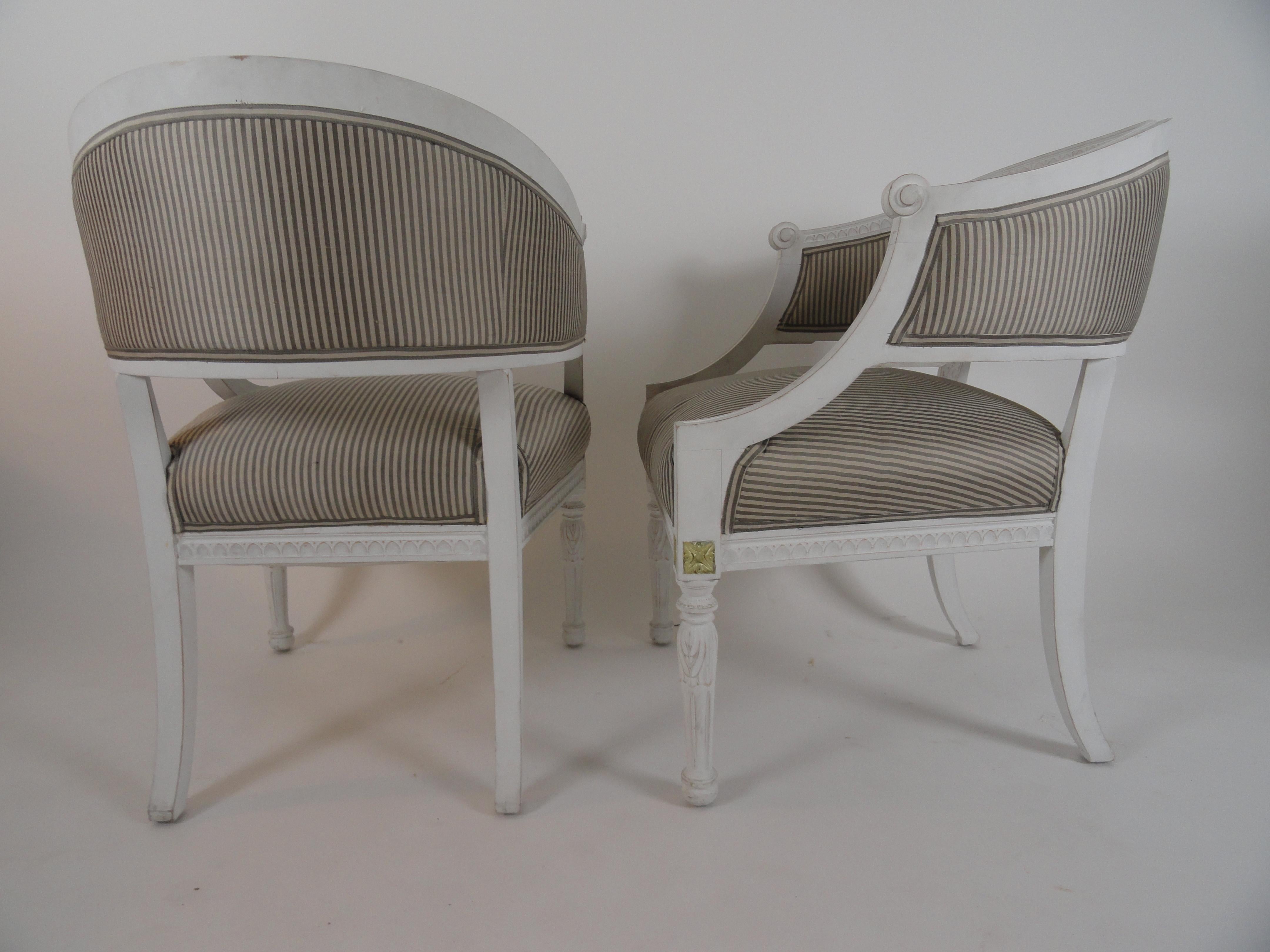 Very nice pair of 19th century Swedish armchairs in excellent condition. Newer painted finish, including silver highlights on carved detail. 
Procured from Angie Tyner Antiques in Atlanta.