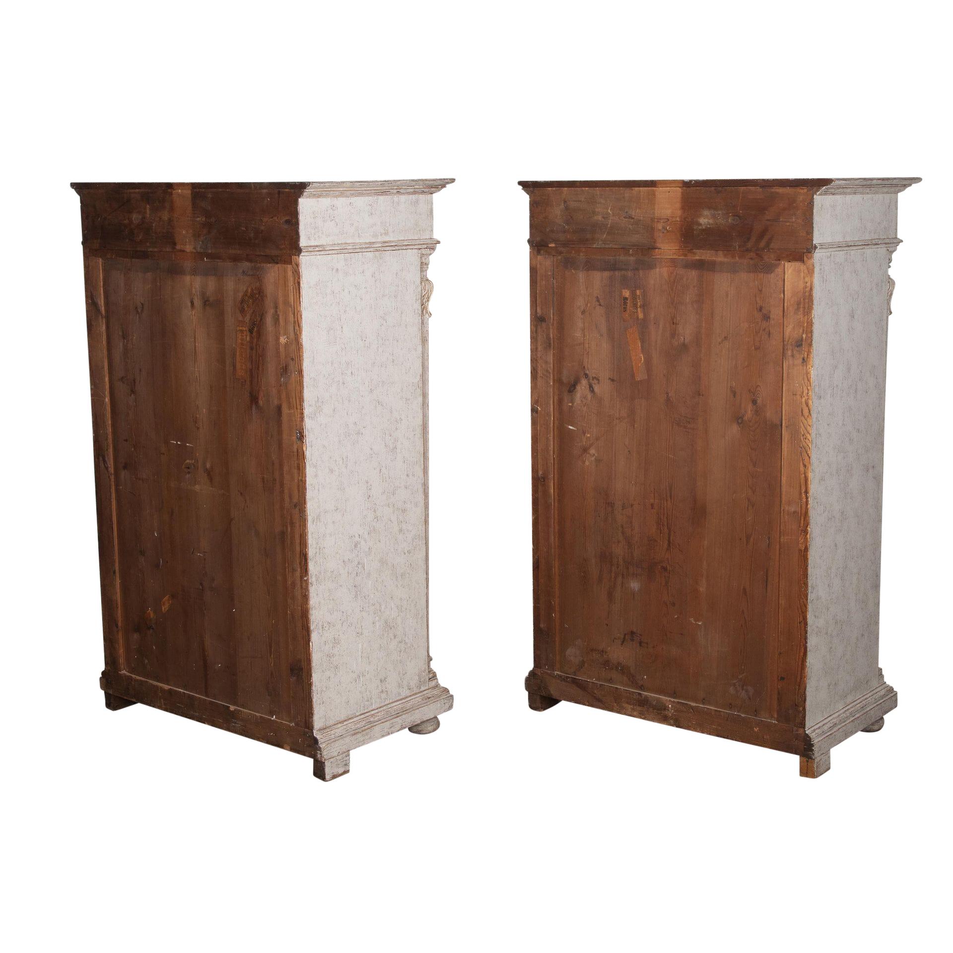 Pair of 19th Century Swedish cabinets.
With decorative carved detailing.
Featuring a top storage drawer and below is a large single door to opening to useful shelf storage.