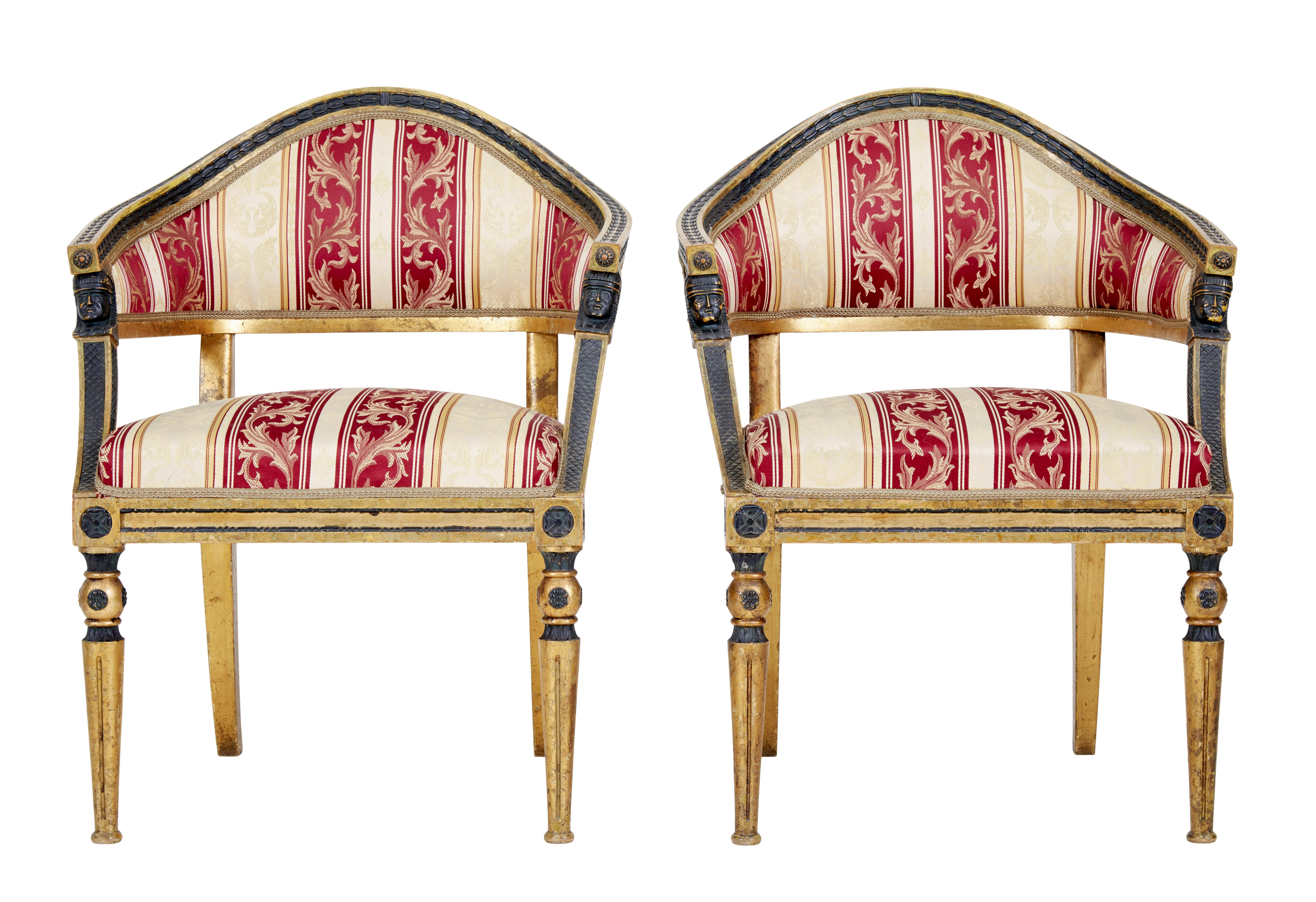 Pair of 19th century Swedish gilt and ebonised armchairs circa 1860.

Pair of fine quality shaped back gilt armchairs. Unusual shaped back with ebonised leaf detailing contrasting with the gilt. Egyptian revival mounts below the arms. Standing on