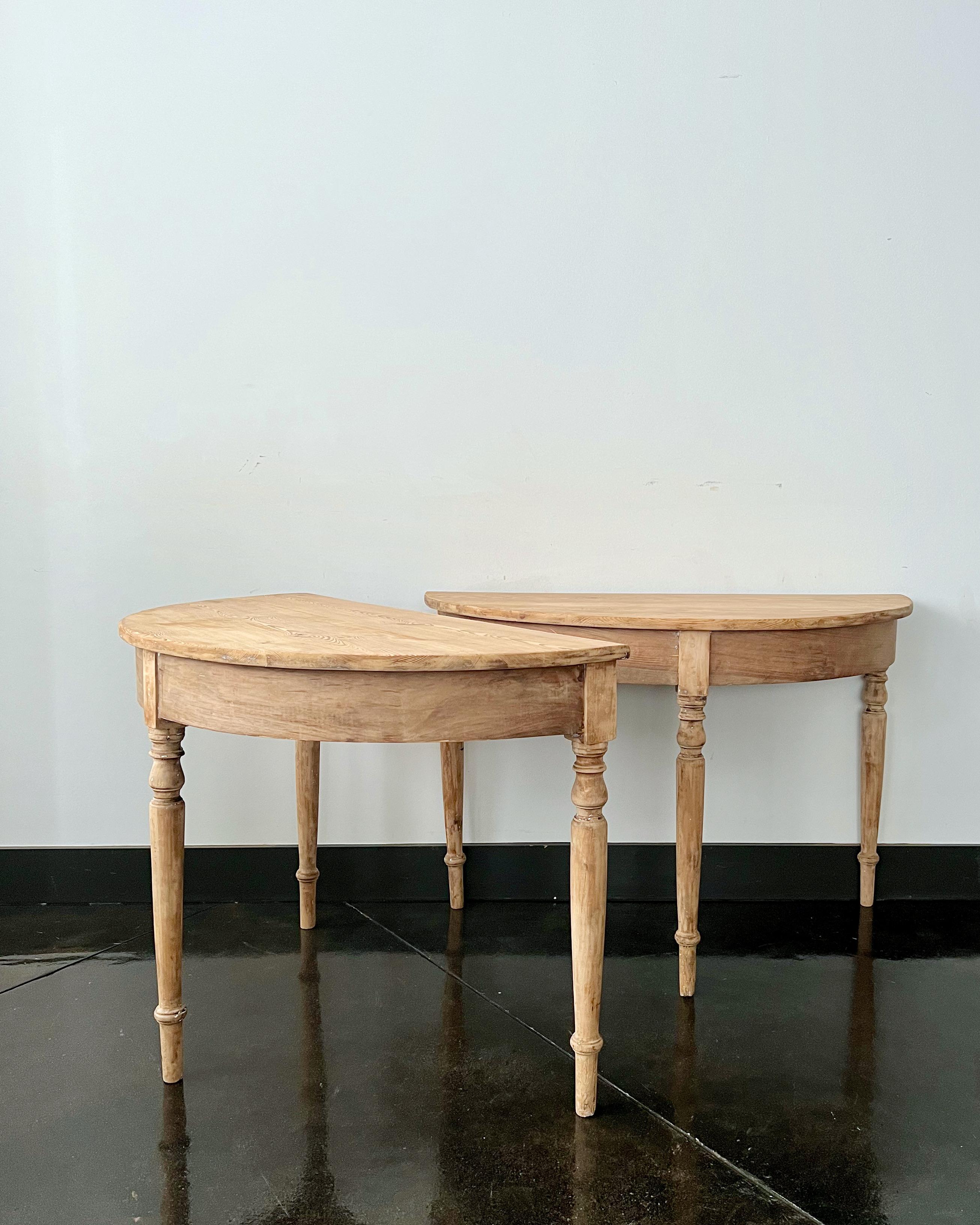 PRICE IS FOR THE PAIR!
A handsome pair 19th century Swedish demilune tables with turned, tapered legs scraped back to traces of it's original color. 
Sweden, circa 1850.
Diameter when together 43