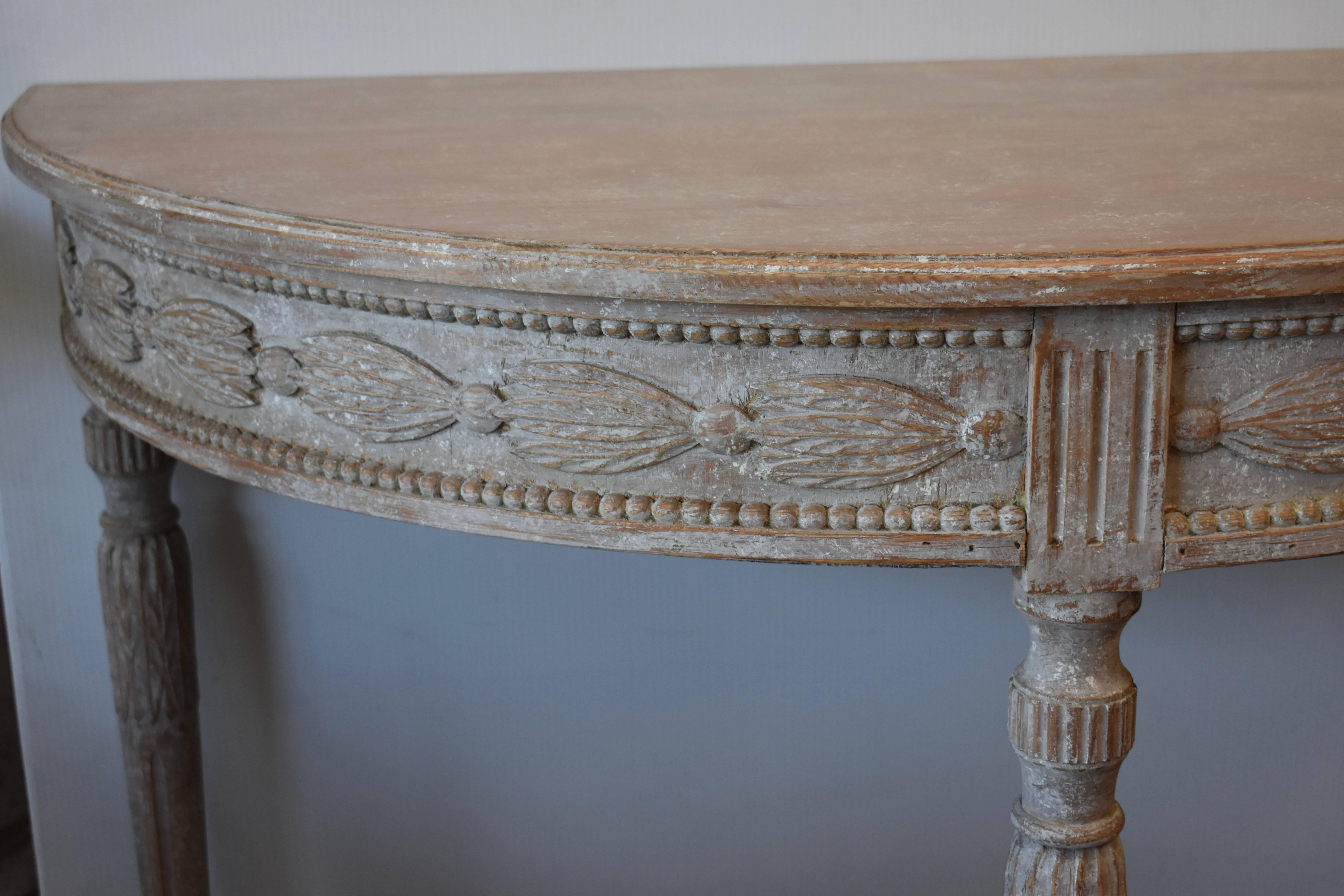 Elegant pair of demilune console tables with beautifully carved apron over lovely tapered fluted legs. Very Pretty. Stockholm, Sweden.