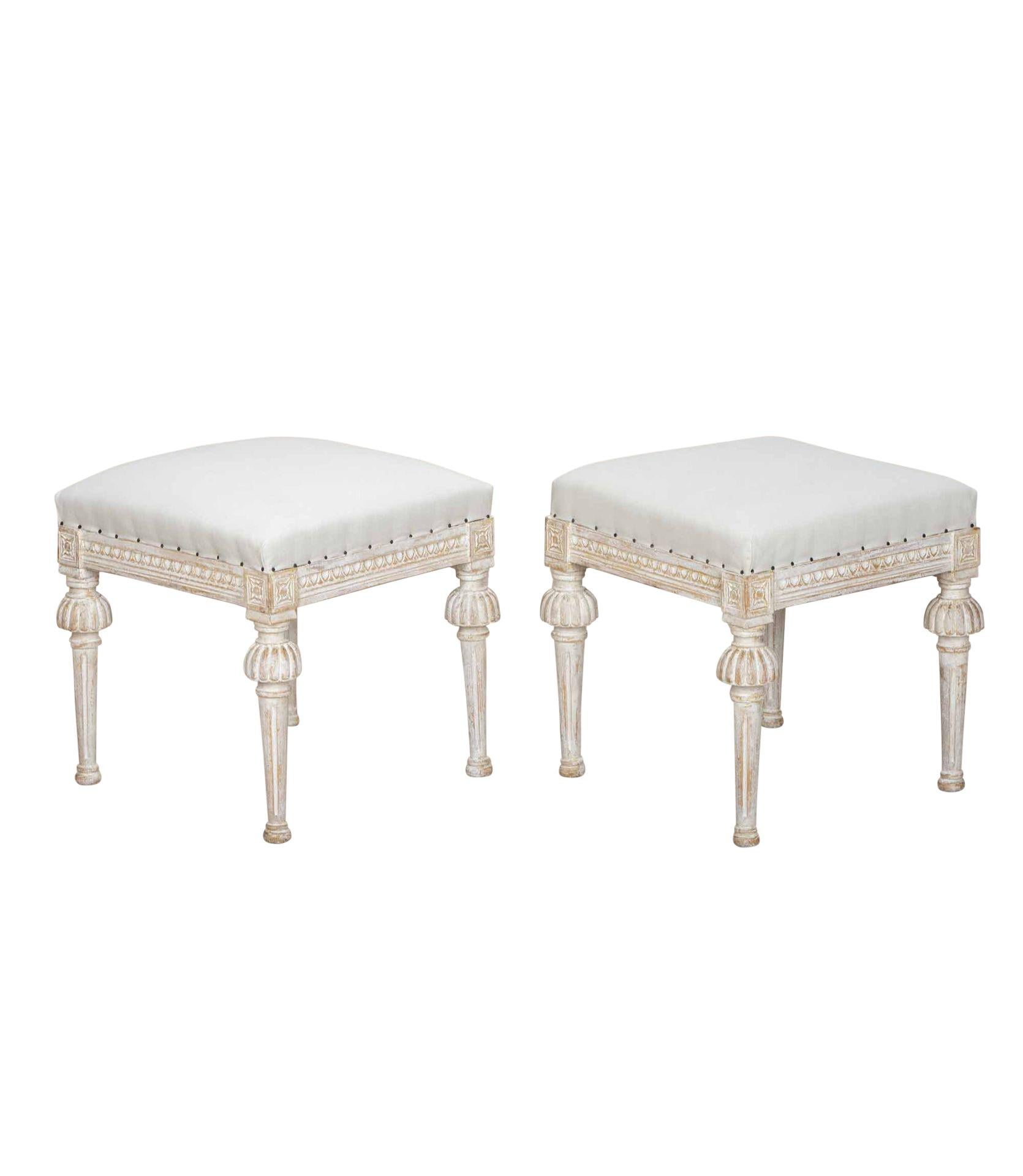 Pair of late 19th Century Swedish footstools.
With decorative carving to the legs and re-upholstered in linen.
Circa 1880.