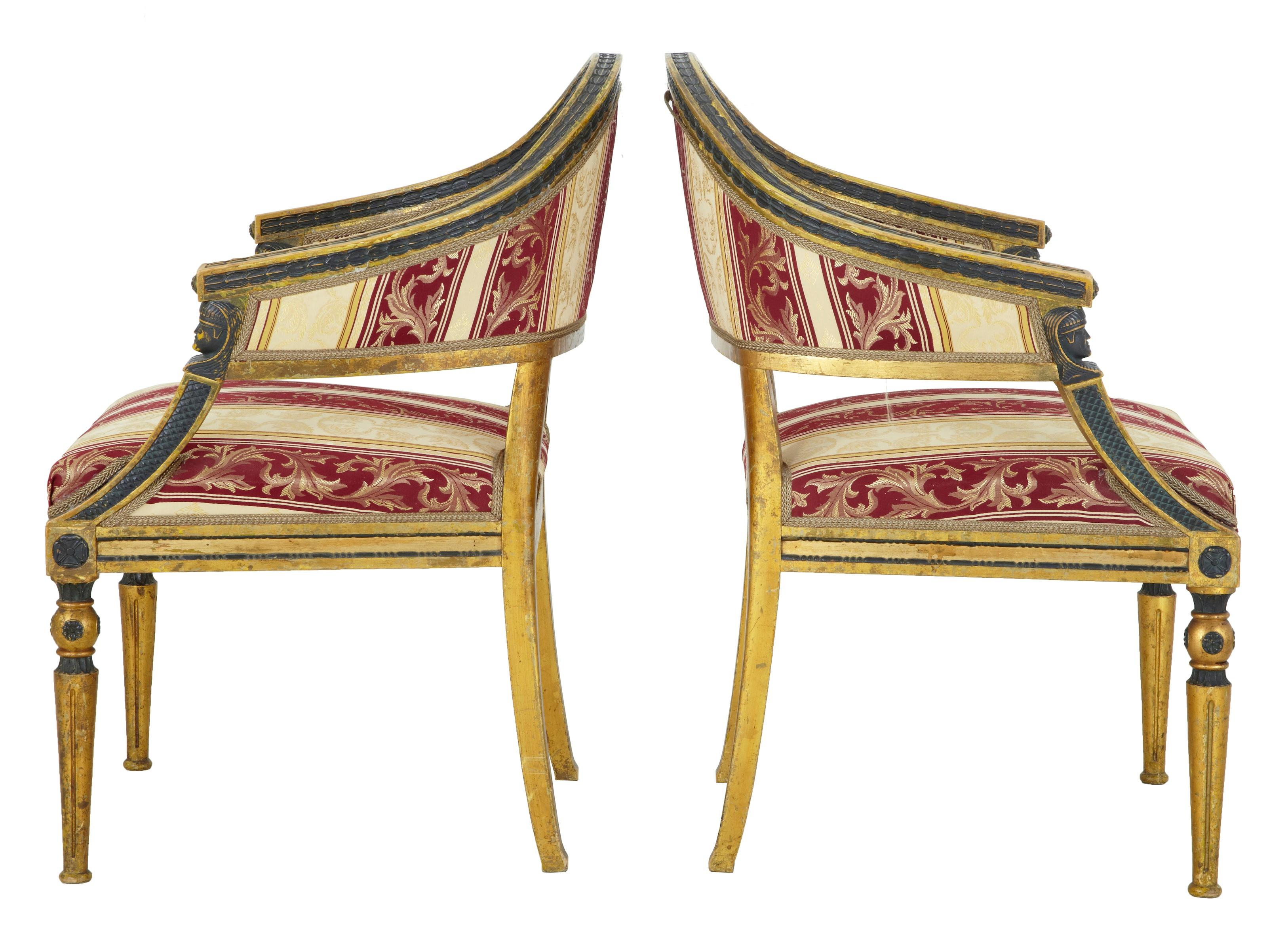 Pair of fine quality shaped back gilt armchairs, circa 1860.
Unusual shaped back with ebonized leaf detailing contrasting with the gilt.
Egyptian style mounts below the arms.
Standing on tapered legs.
Upholstered in later silk material.

Seat