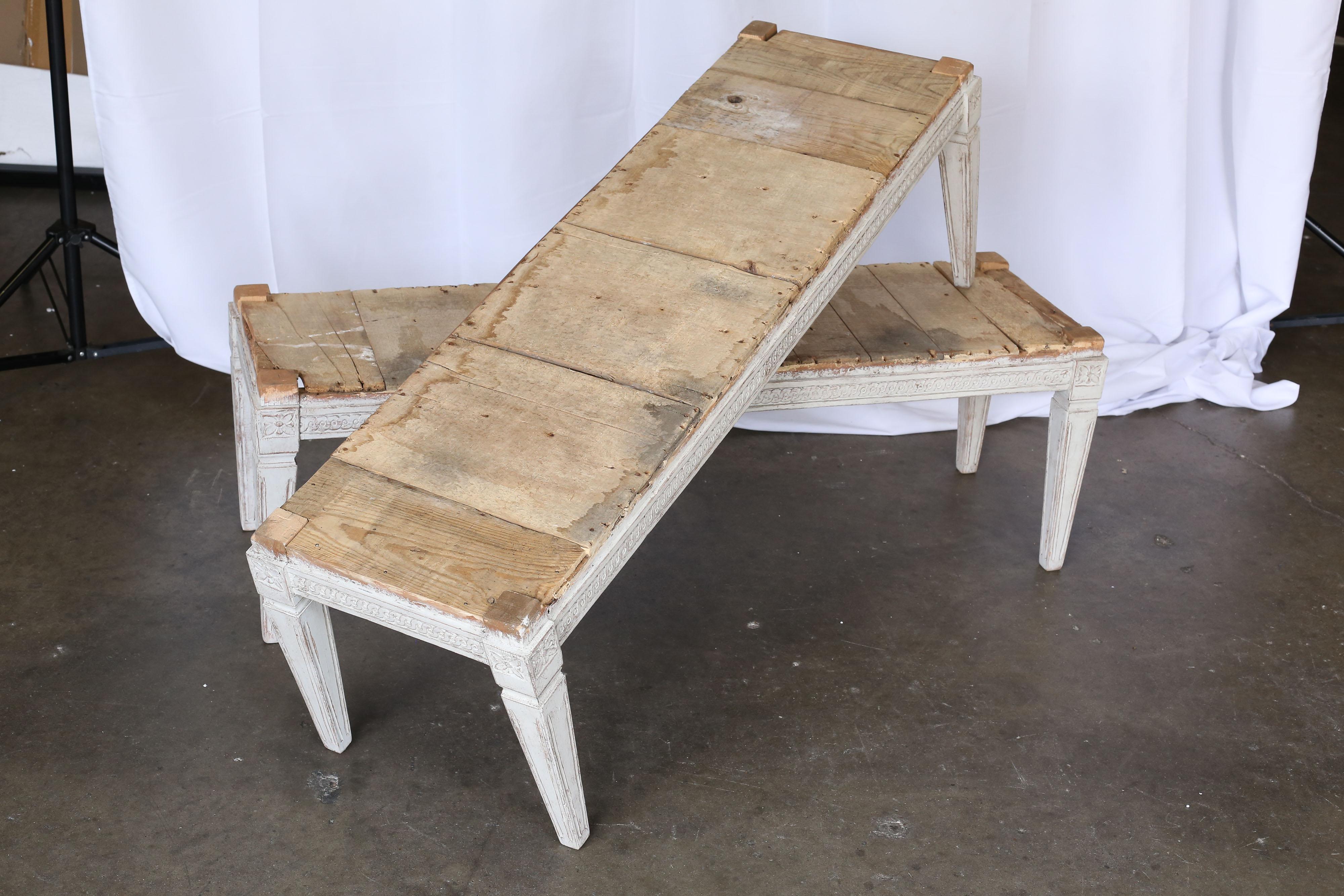 19th century Swedish Gustavian benches with carving around all sides and tapered square legs. Price is for pair.