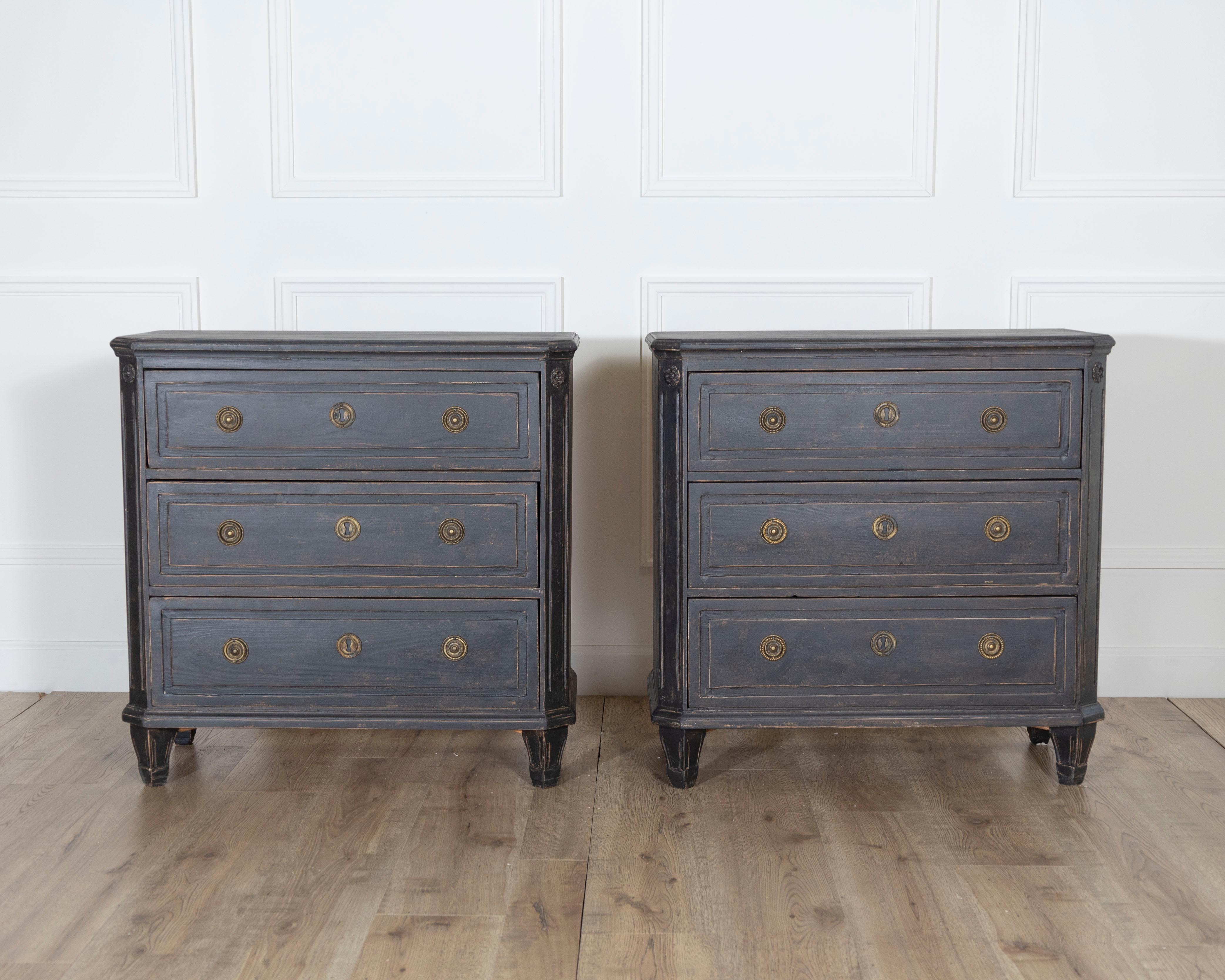 A refined pair of Swedish chests of drawers, circa 1880, offering timeless elegance and understated sophistication. These pieces are crafted in solid wood and feature a beautifully aged black painted finish with subtle distressing that enhances