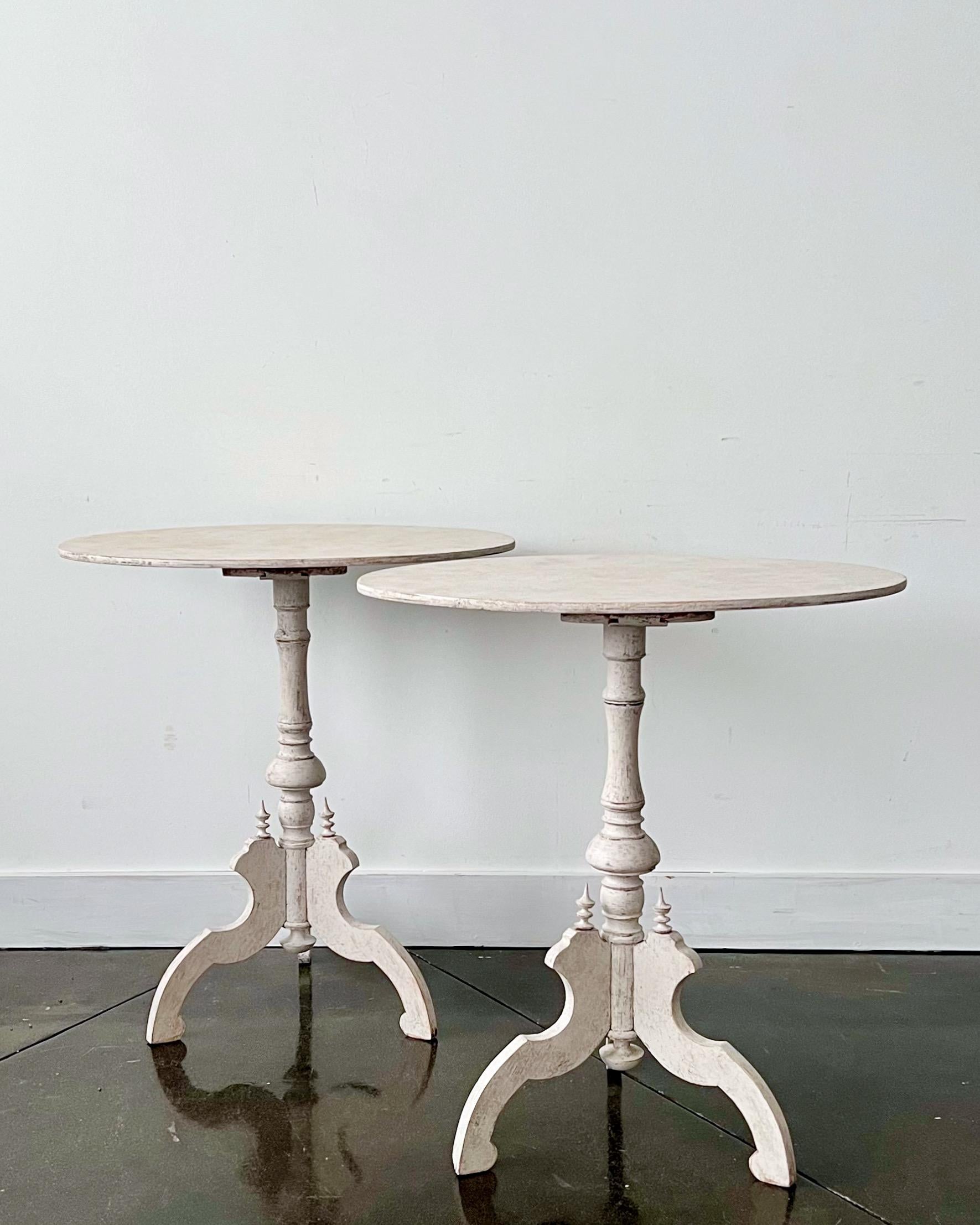 A pair of charming  pedestal tables with oval tops and turned bases supported by intricately carved scrolling legs in Gustavian style.
Värmland, Sweden, circa 1850.