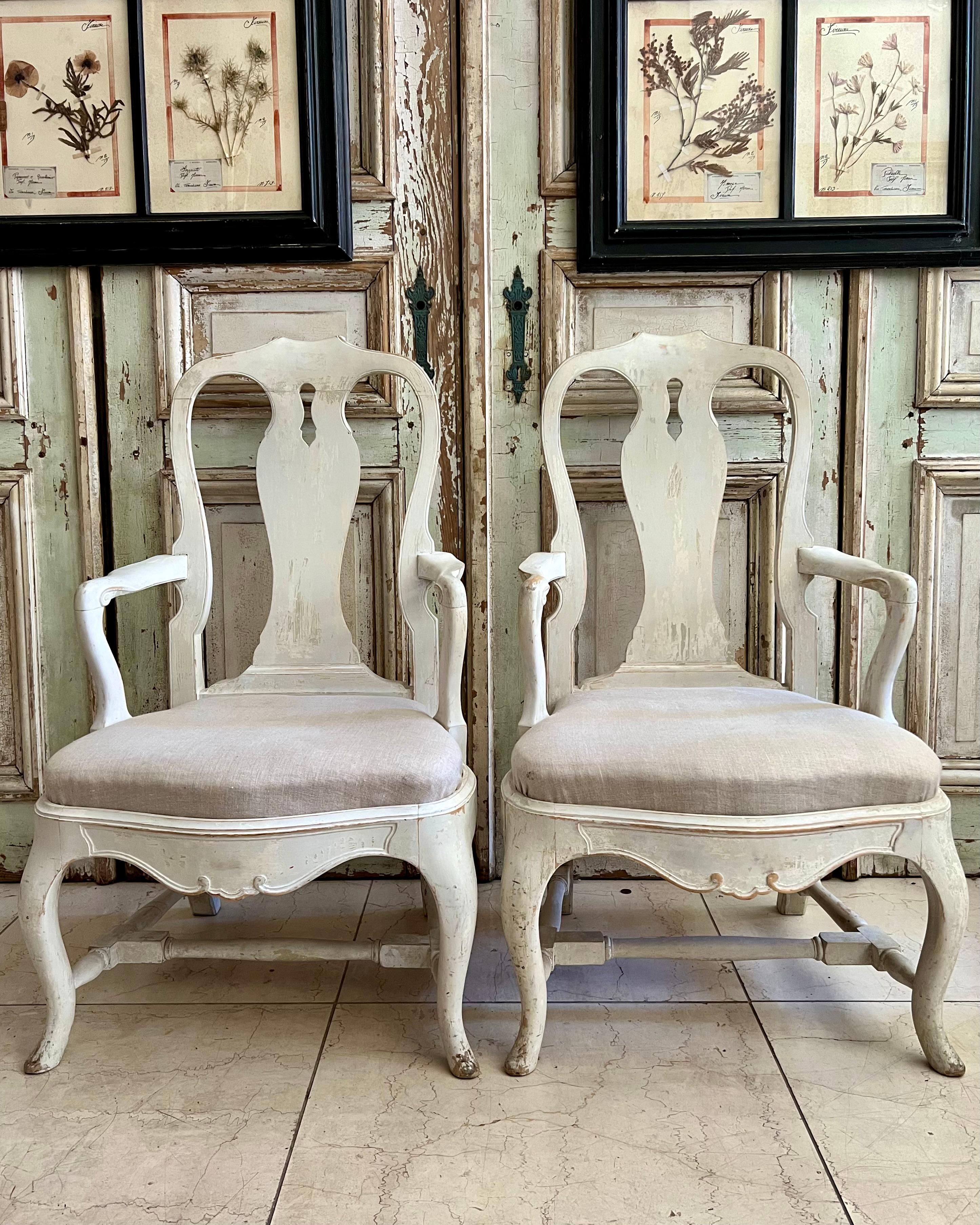A pair of 19th century Rococo style Armchair in draped old paint finish, pierced back, carved splats and apron - resting on cabriole legs.
Movable seat cushion covered in palest color linen.
Very heavy solid wood and sturdy chairs.