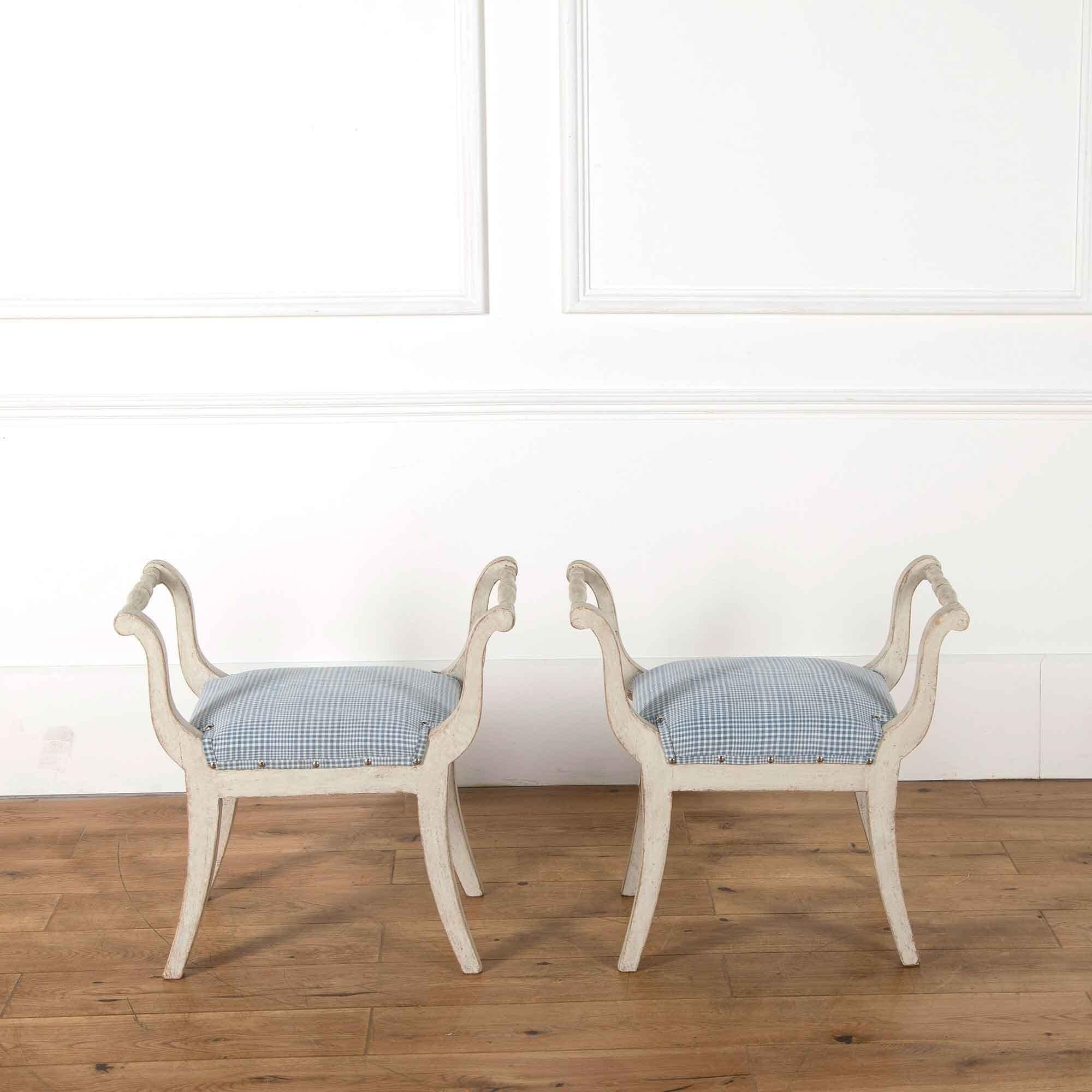 A pair of 19th century painted Gustavian style stools recovered in antique Alsace linen.