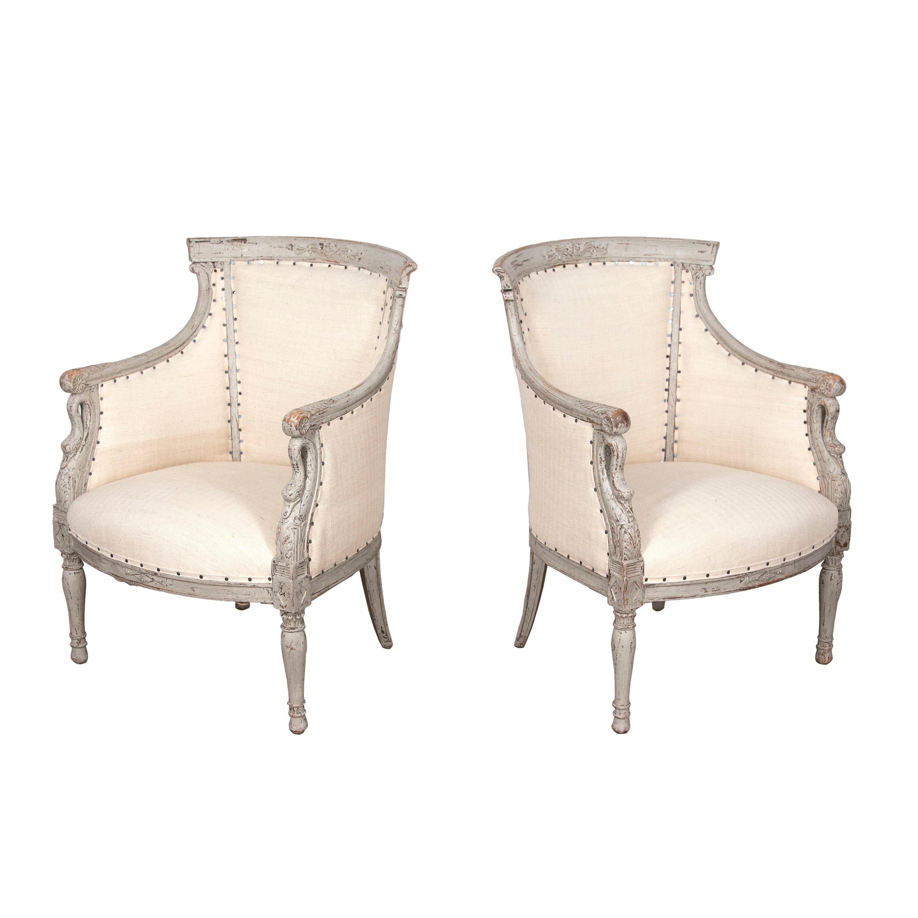 Pair of 19th century Swedish carved wooden chairs. 
With decorative detailing to the arms, and curtailing to swans.
Both are repainted and reupholstered in antique hemp.
Circa 1850.