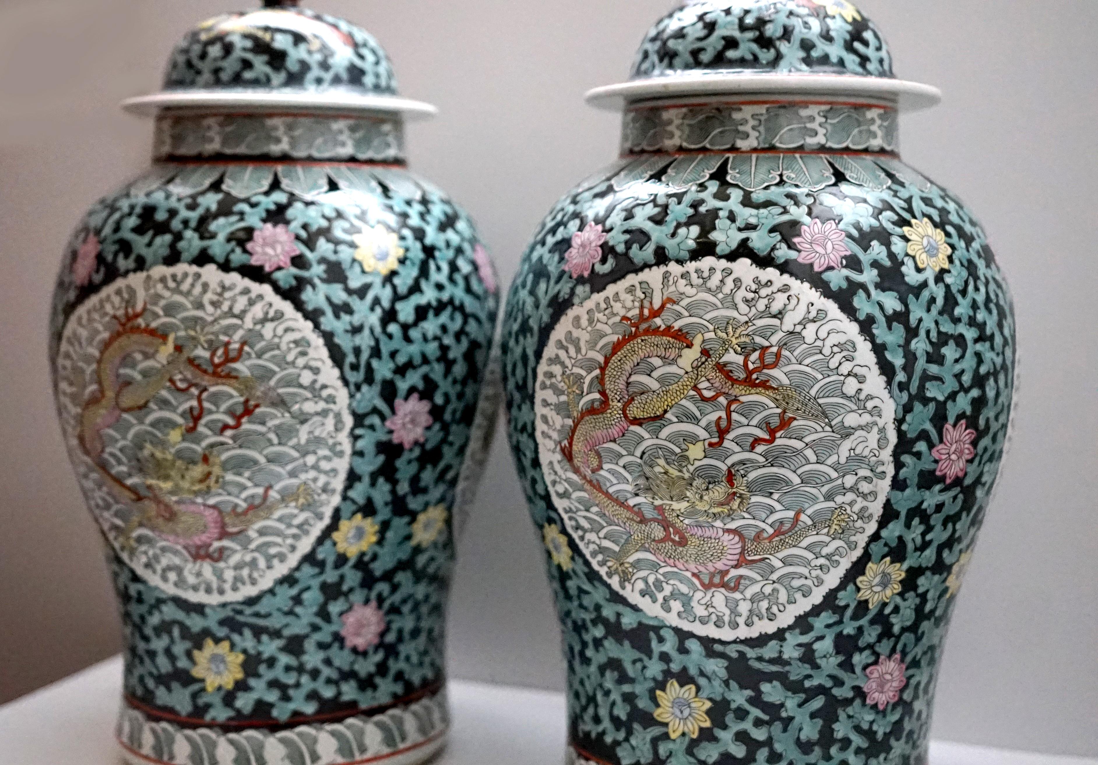 This distinctive pair of dragon temple jars is worth collecting. The blue pattern and design on black ground of dragons are characteristic of the jars, which originated in East Asian temples. This pair bears the traditional auspicious  dragons which