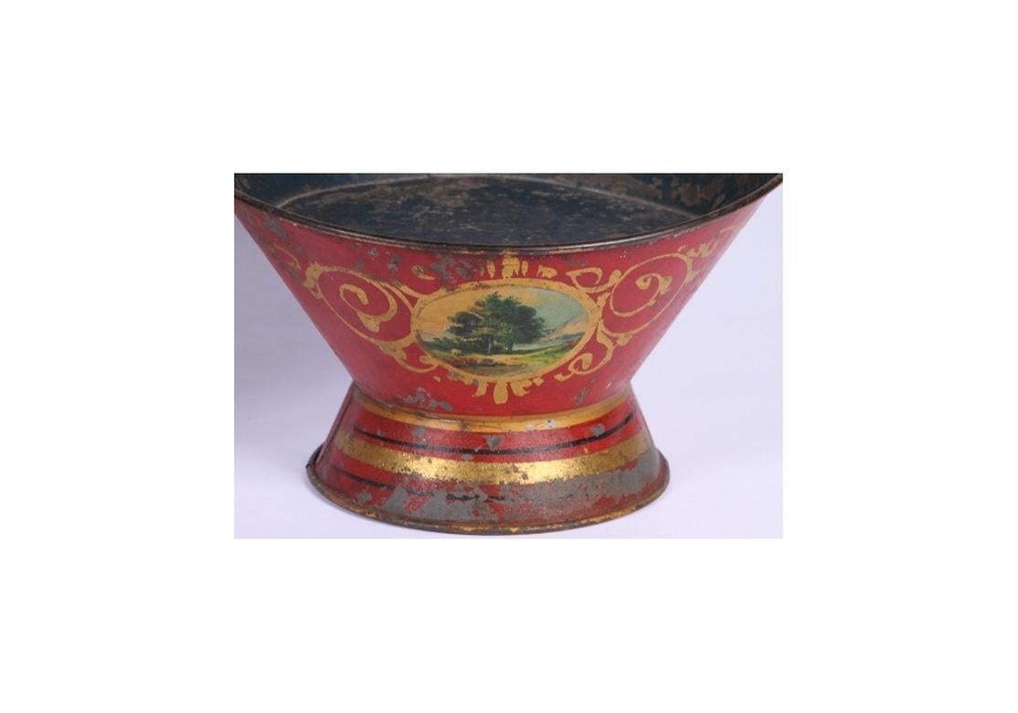 Fine pair of rarely seen tub form antique planters. Red painted with gilded scrolls surrounding an everygreen tree. Flared base has stripes of gilt and black. Interior is teal blue. The overall condition is very good with some expected paint loss