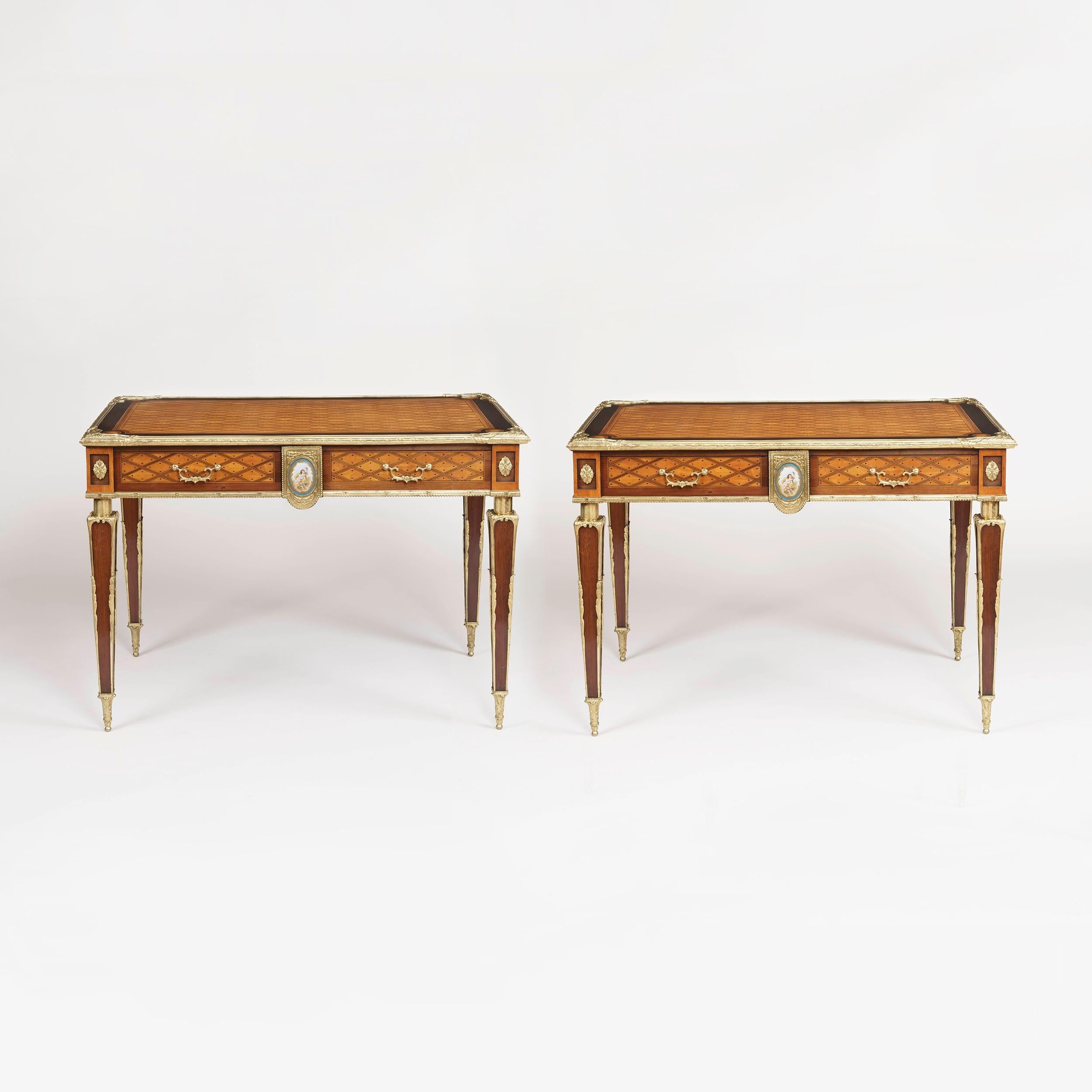 A rare pair of tables attributed to Donald Ross of London

Constructed in citronnier, ebony and harewood, and dressed with a porcelain plaque in the 'Sevres' manner, and adorned with very fine bronze mounts. Throughout, the 'trellis and dot'
