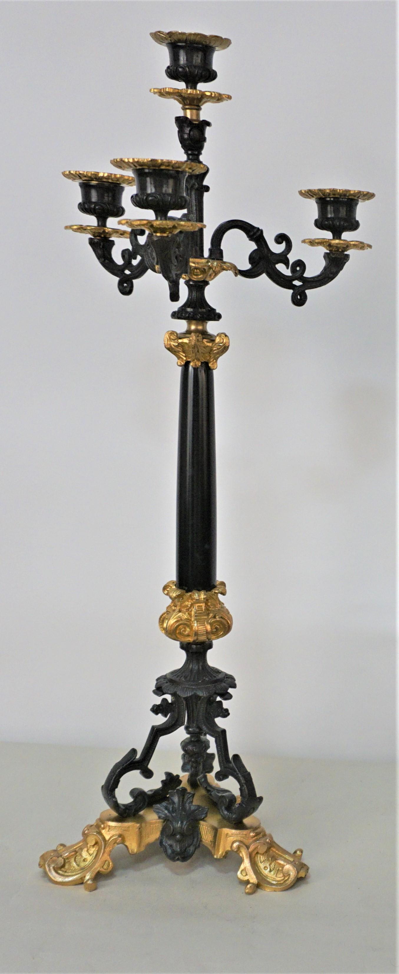 Pair of four branch two color bronze with black marble center column candelabras.