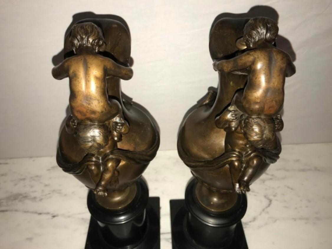 Pair of 19th Century Urns on Marble Stands Bearing Cherubs and Rams Heads For Sale 3