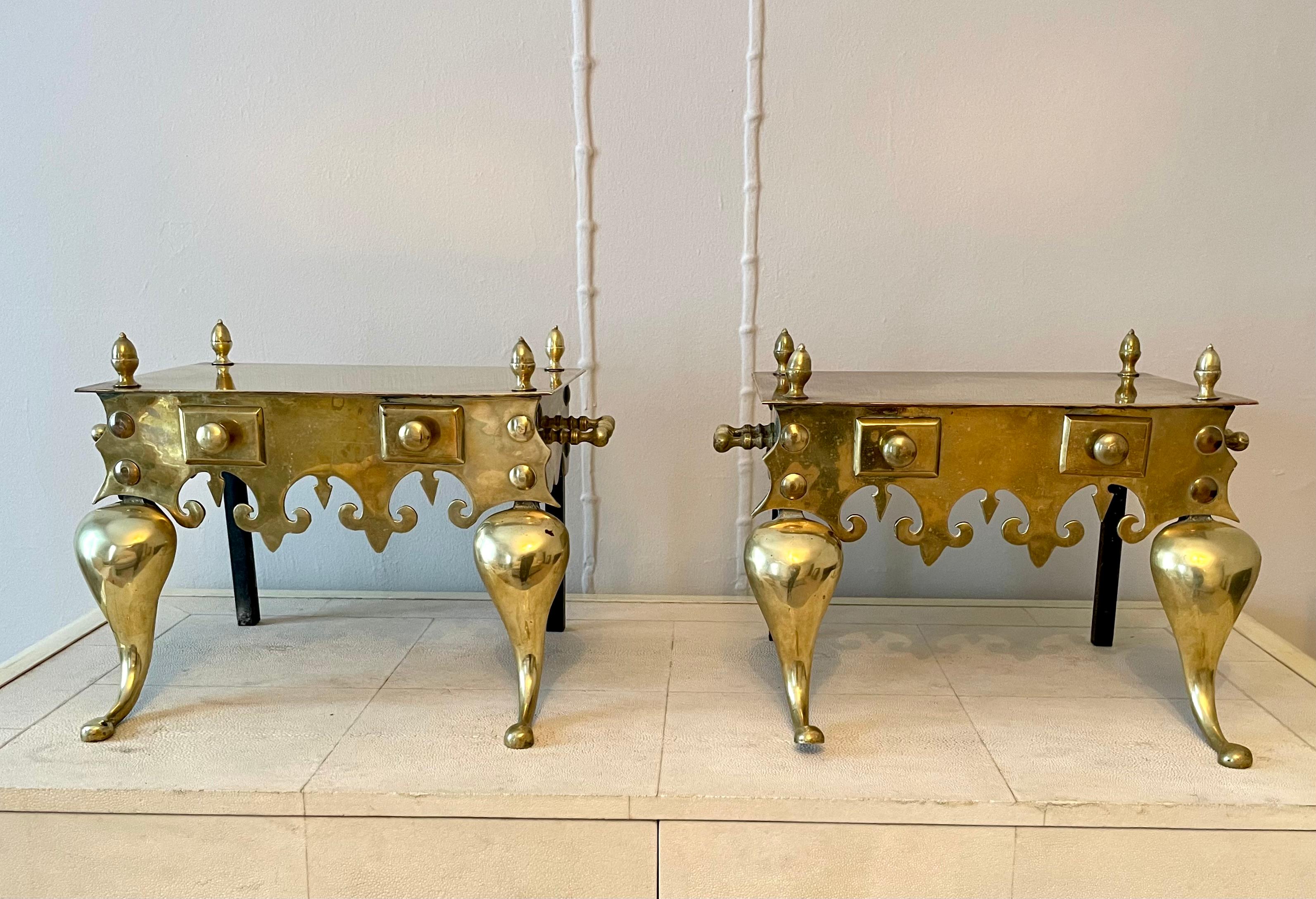 The footman was used to keep pots warm in the fireplace. 

Pair of Victorian brass footman stools with shaped frieze and decorative knob fixtures. Handles on either side and gorgeous finials on all for corners.

The excellent craftsmanship and