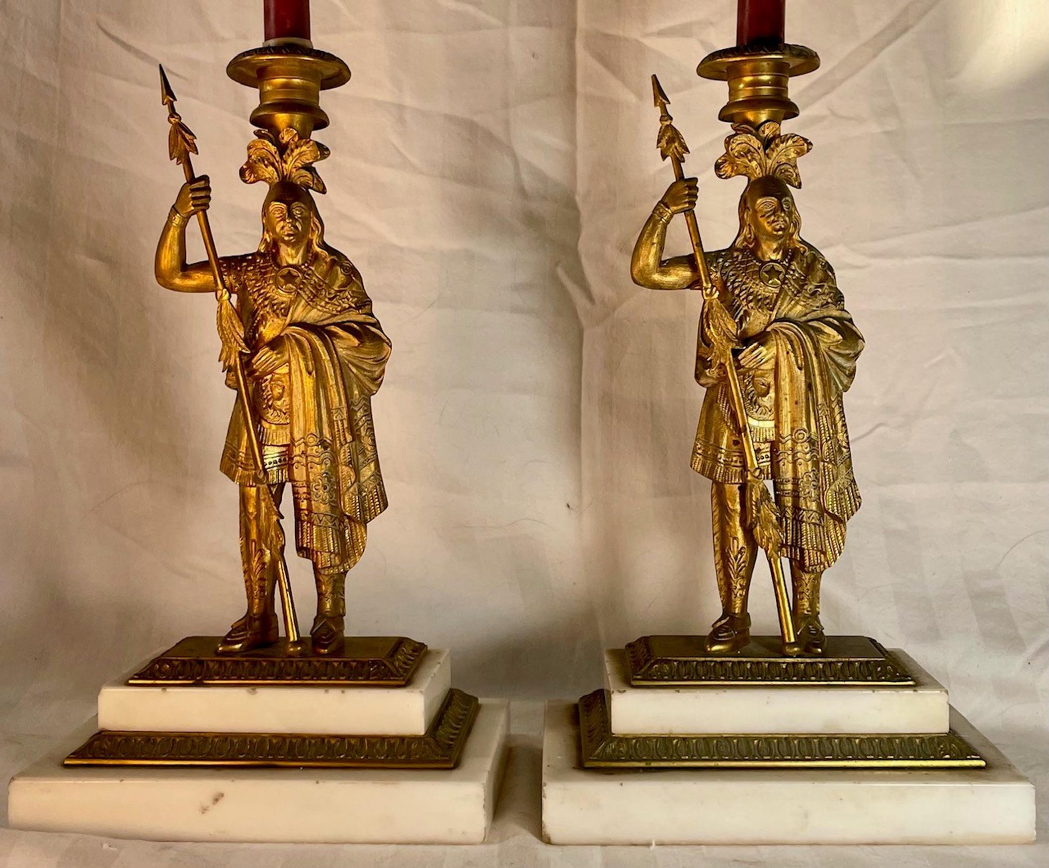 Pair of 19th century Victorian bronze and Ormolu figural candlesticks. 

Period Victorian deeply embossed bronze and ormolu candlesticks. This pair of the most beautiful and elegant English candleholders features an early impression of American