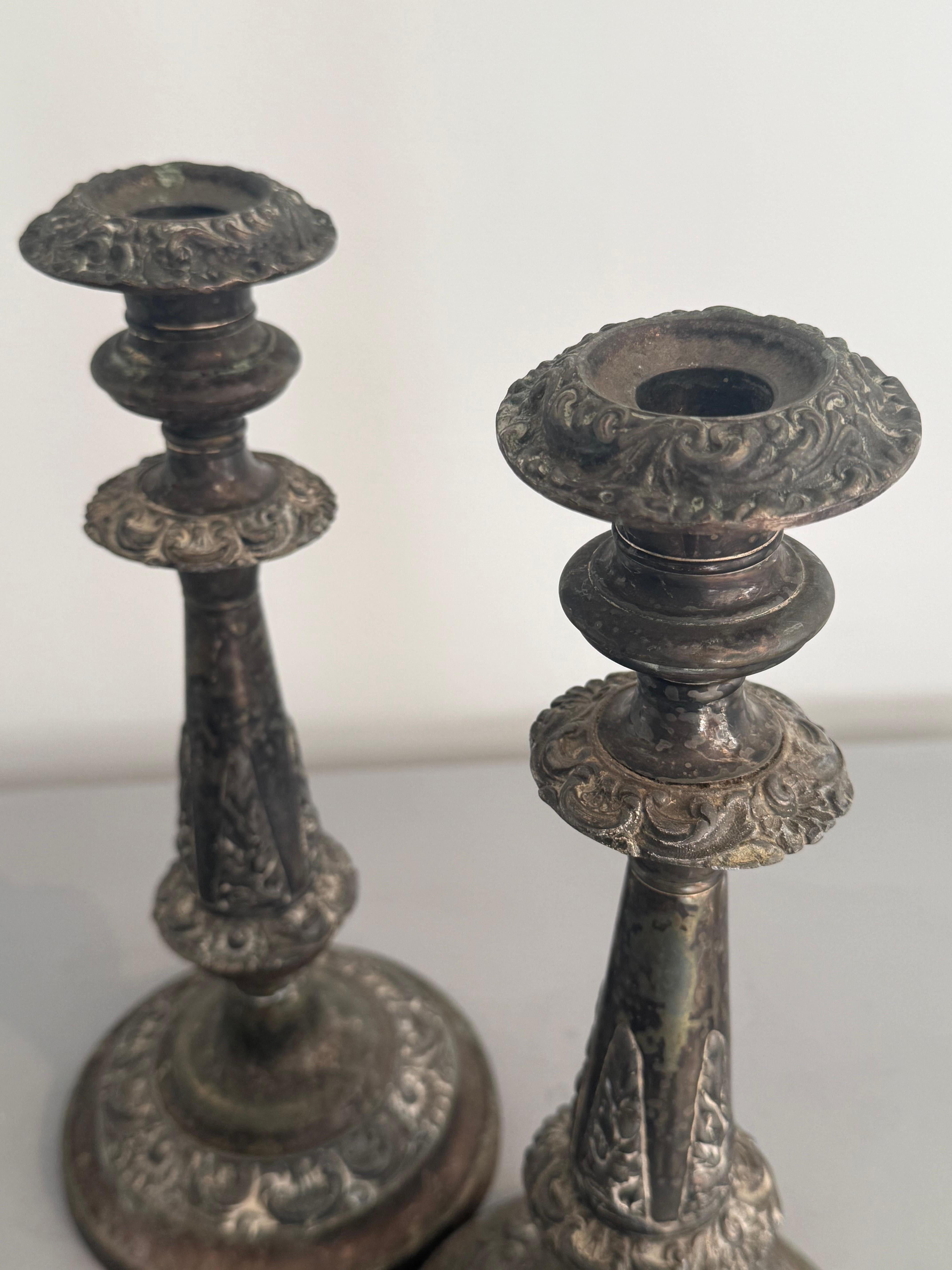 A very nice decorative pair of Victorian candle sticks. Originally they were silver plated which has now worn beautifully giving them a great decorative look and charm. Loaded on the bases to add weight. Removable candle sconces for cleaning. 
These