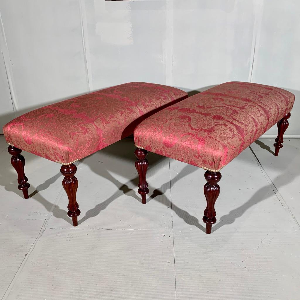 Rare and very decorative pair of Victorian long stools, fully restored and fully re upholstered.
The stools have these fabulous turned and reeded, bulbous semi tulip style legs with a lovely rich mahogany colour tone to them and polished up very