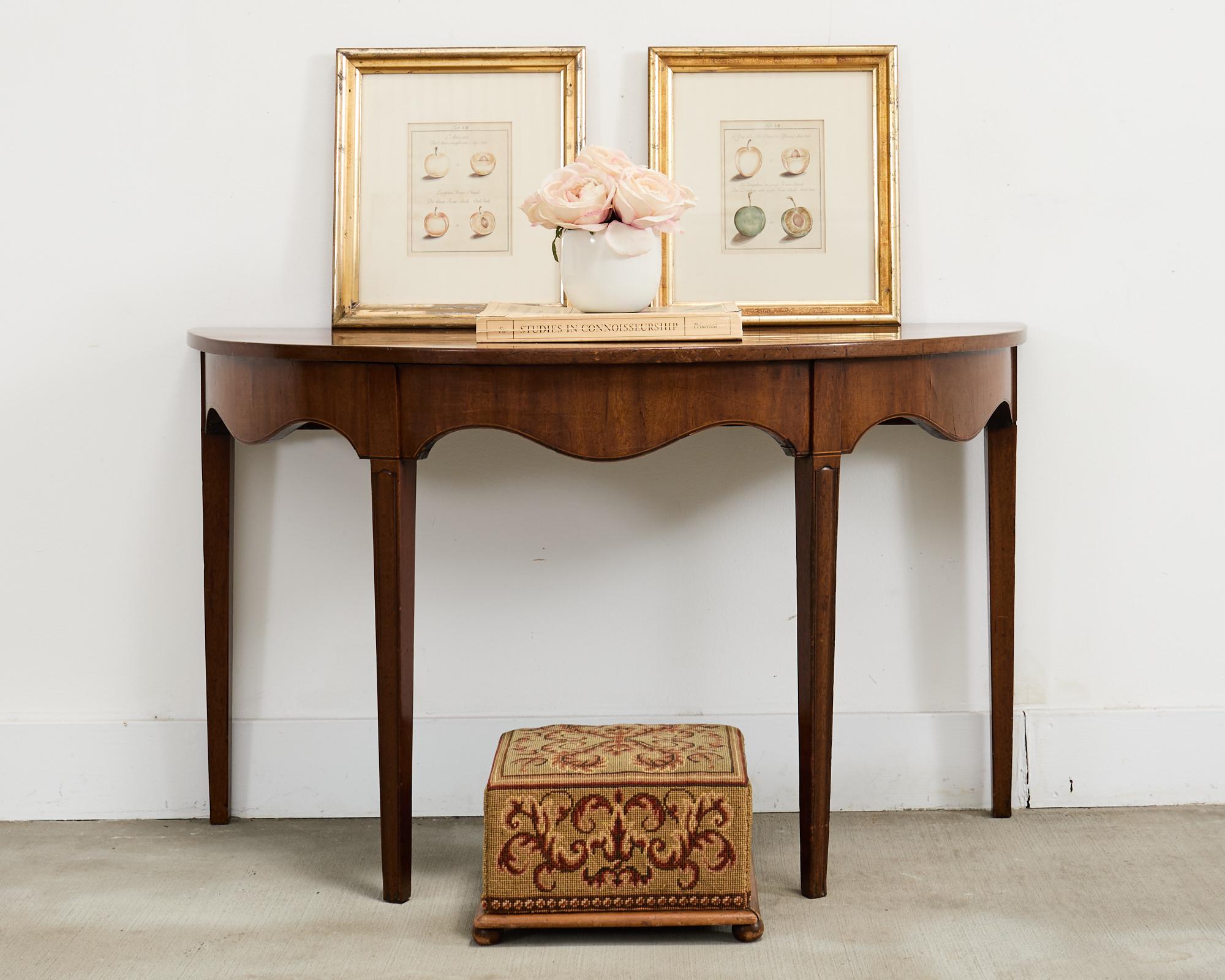 Charming pair of late 19th-century English Victorian footstools featuring fine needlepoint upholstery with a scrollwork motif. The stools have a square-shaped pine frame that is solid and sturdy with an exposed wood trim base. The squares are
