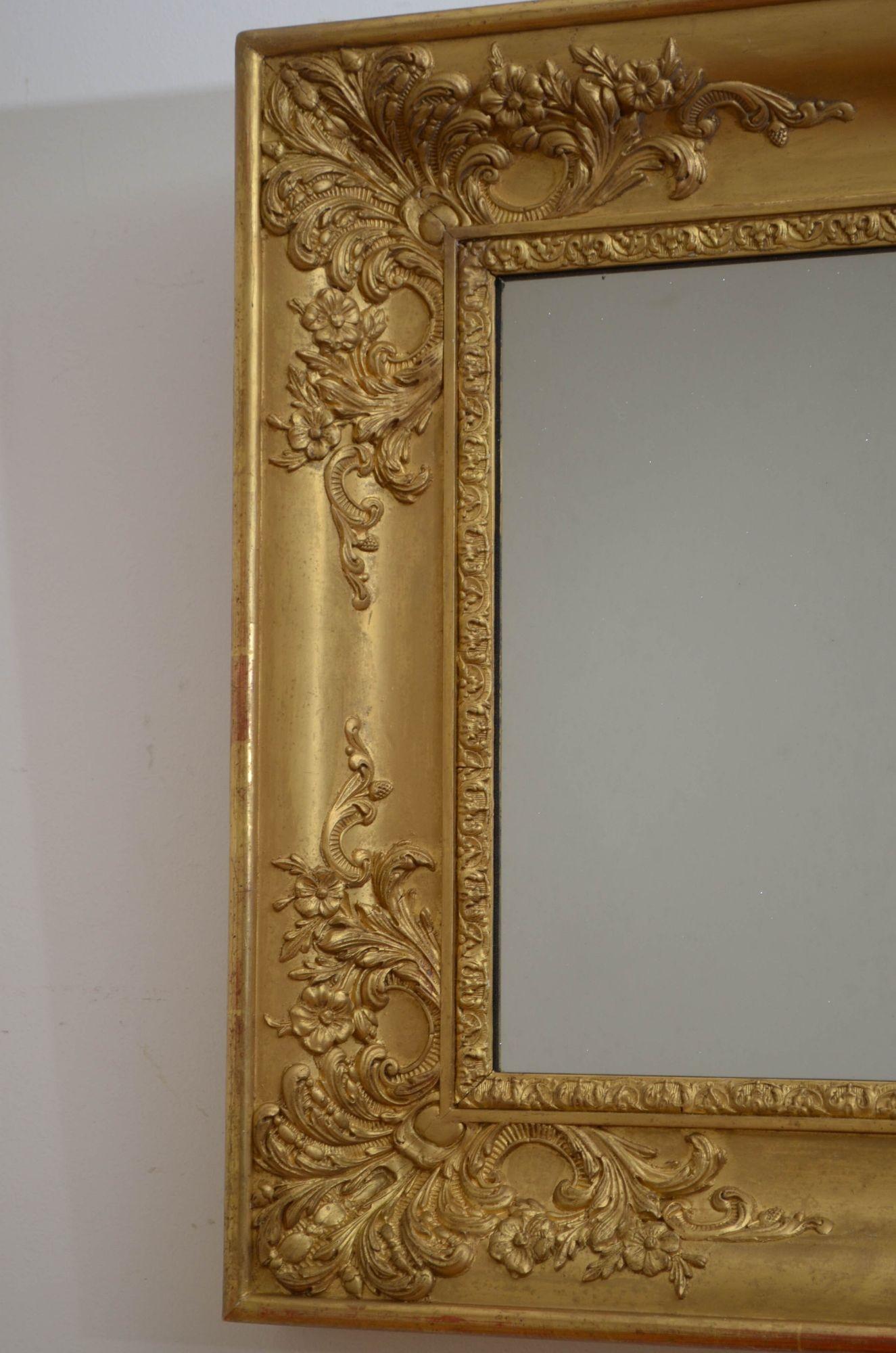 Sn5385 Matching pair of XIXth century wall mirror, each having old mirror plate with some foxing and minor imperfections in shaped gilded frame with floral carvings to four corners. This antique pair of mirrors is in home ready condition.