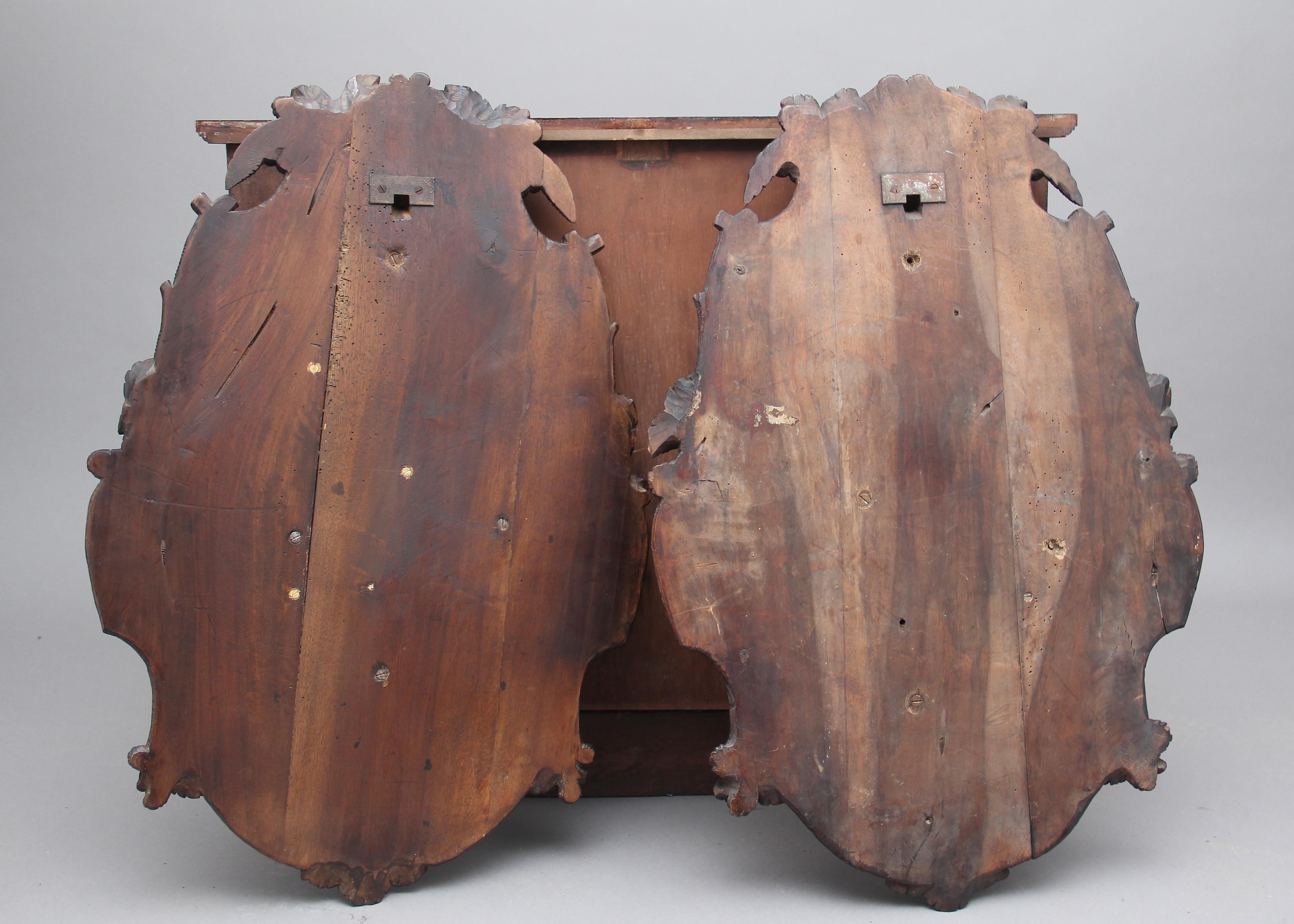 A pair of 19th century walnut black forest wall plaques of superb quality, the oval and carved shaped plaques depicting beautifully detailed game birds and various foliage, circa 1880.

 