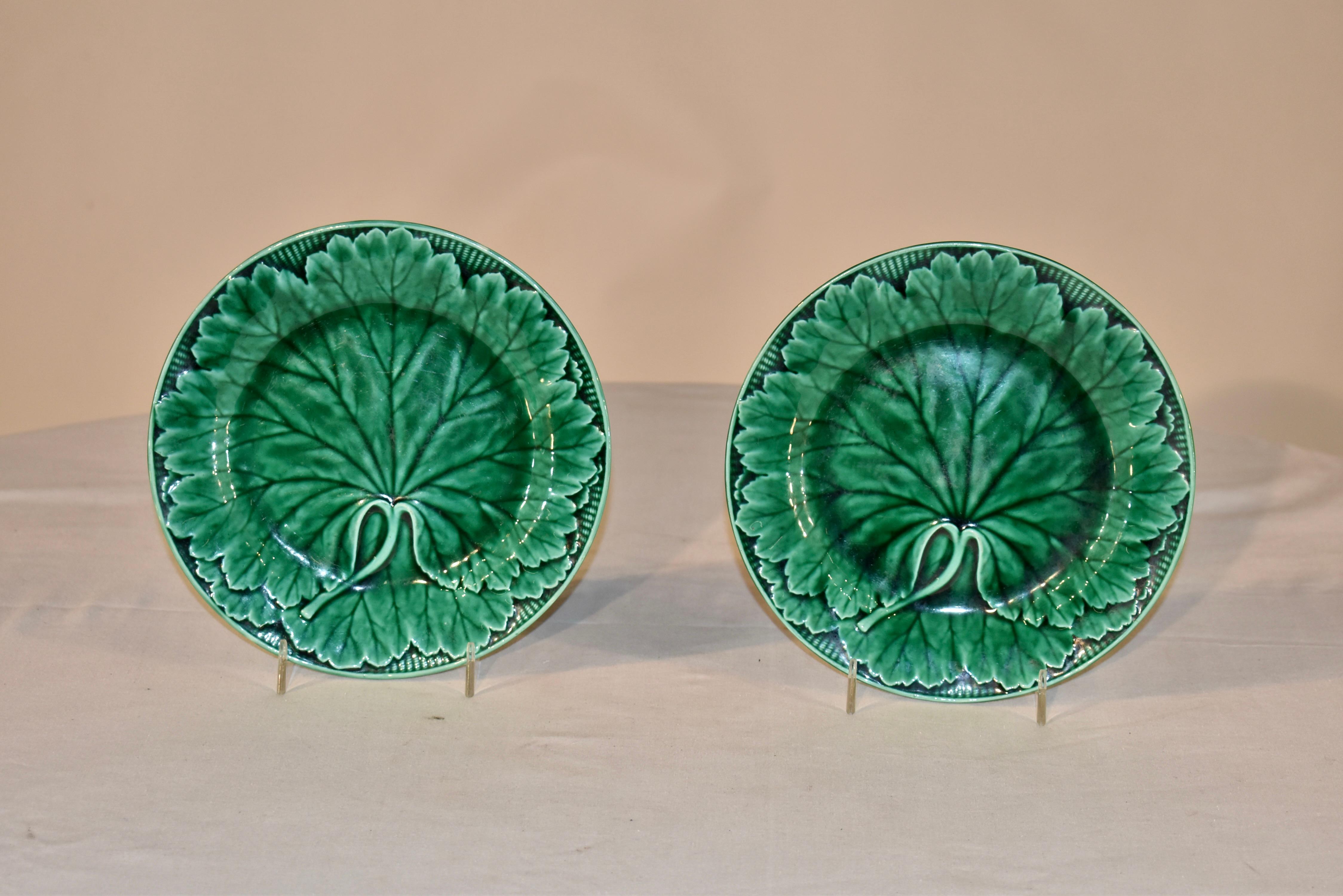 Pair of 19th century Wedgwood Majolica plates with a woven basket and leaf pattern. The basket pattern is around the border of the plate, and the central design is of large leaf with a prominent stem at the base of the leaf. They are simple and