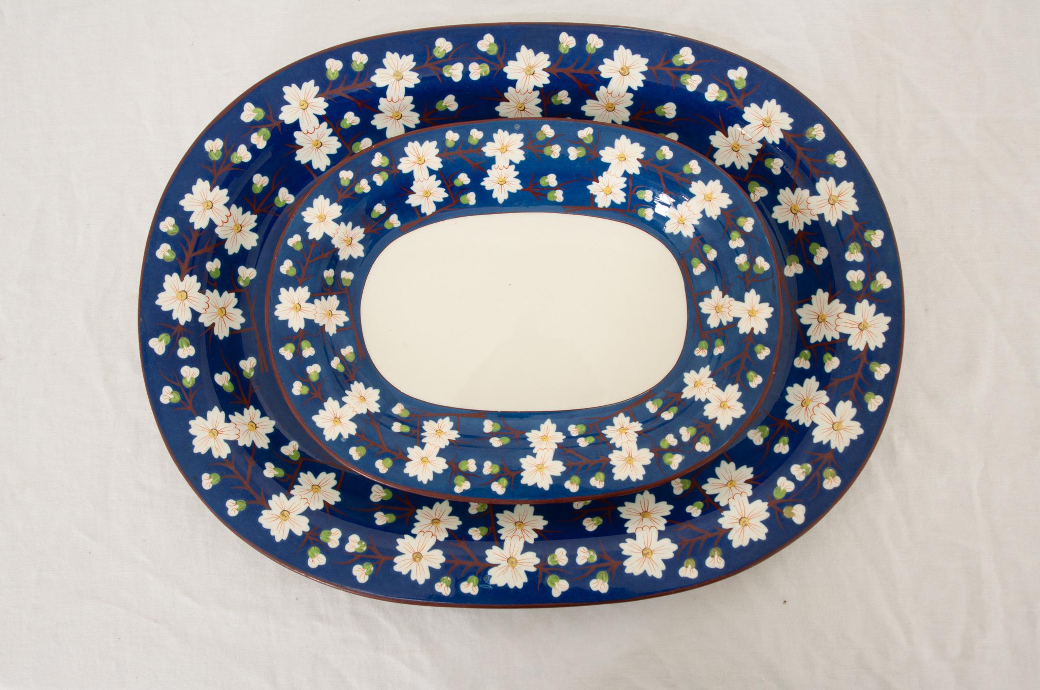 A rare pair of early 19th century Wedgwood pearlware platters made in England circa 1820.  These splendid platters feature a rich lustrous cobalt trim on creamware with a blue underglaze that can be seen throughout, an alternating mix of white