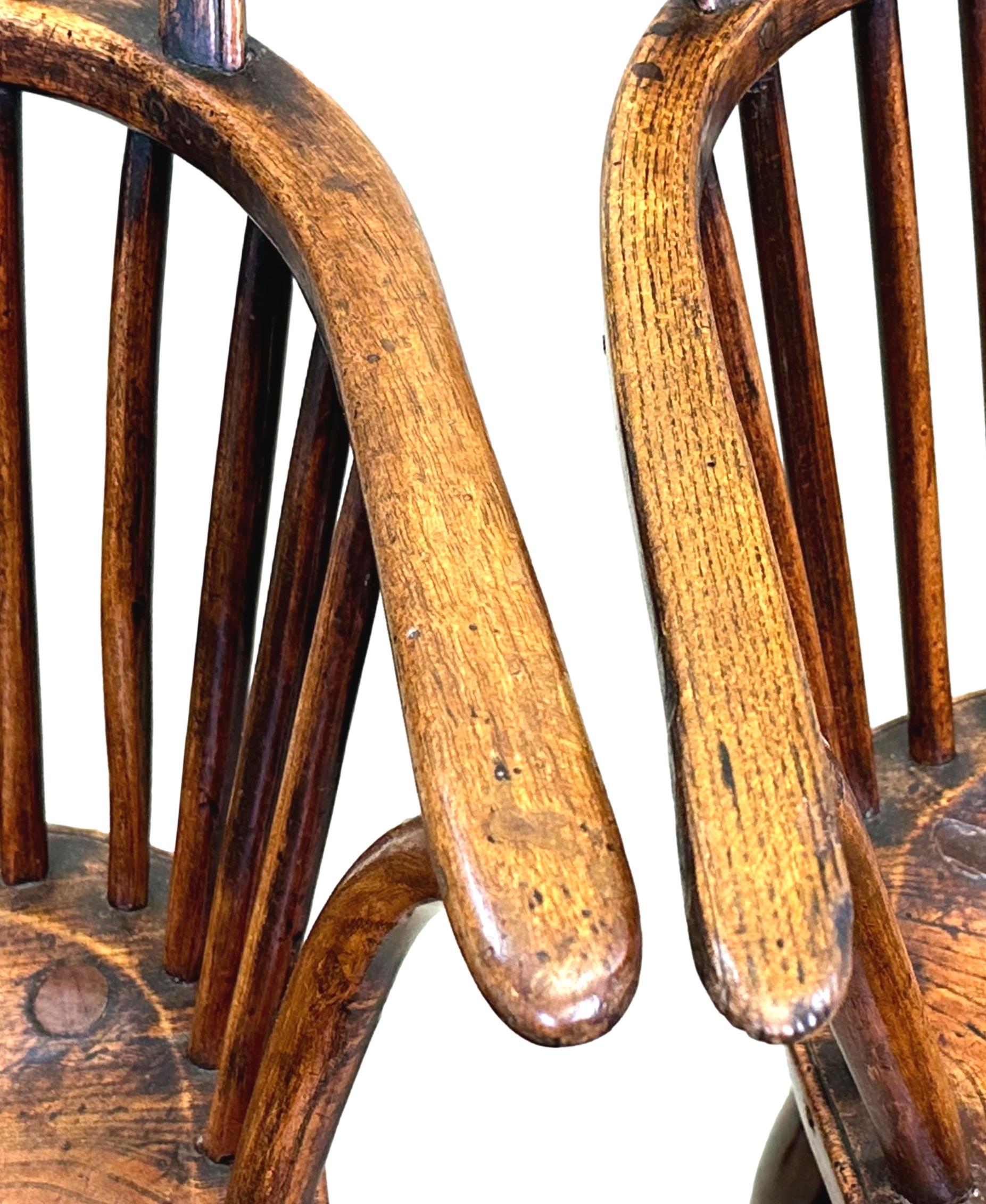An Extremely Attractive Early 19th Century English Pair Of Ash And Elm Windsor Armchairs, Having Hooped Backs With Elegant, Attractive, Pierced Wheelbacks Over Well Figured Seats And Elegant Turned Legs United By Turned H Stretchers.


Windsor