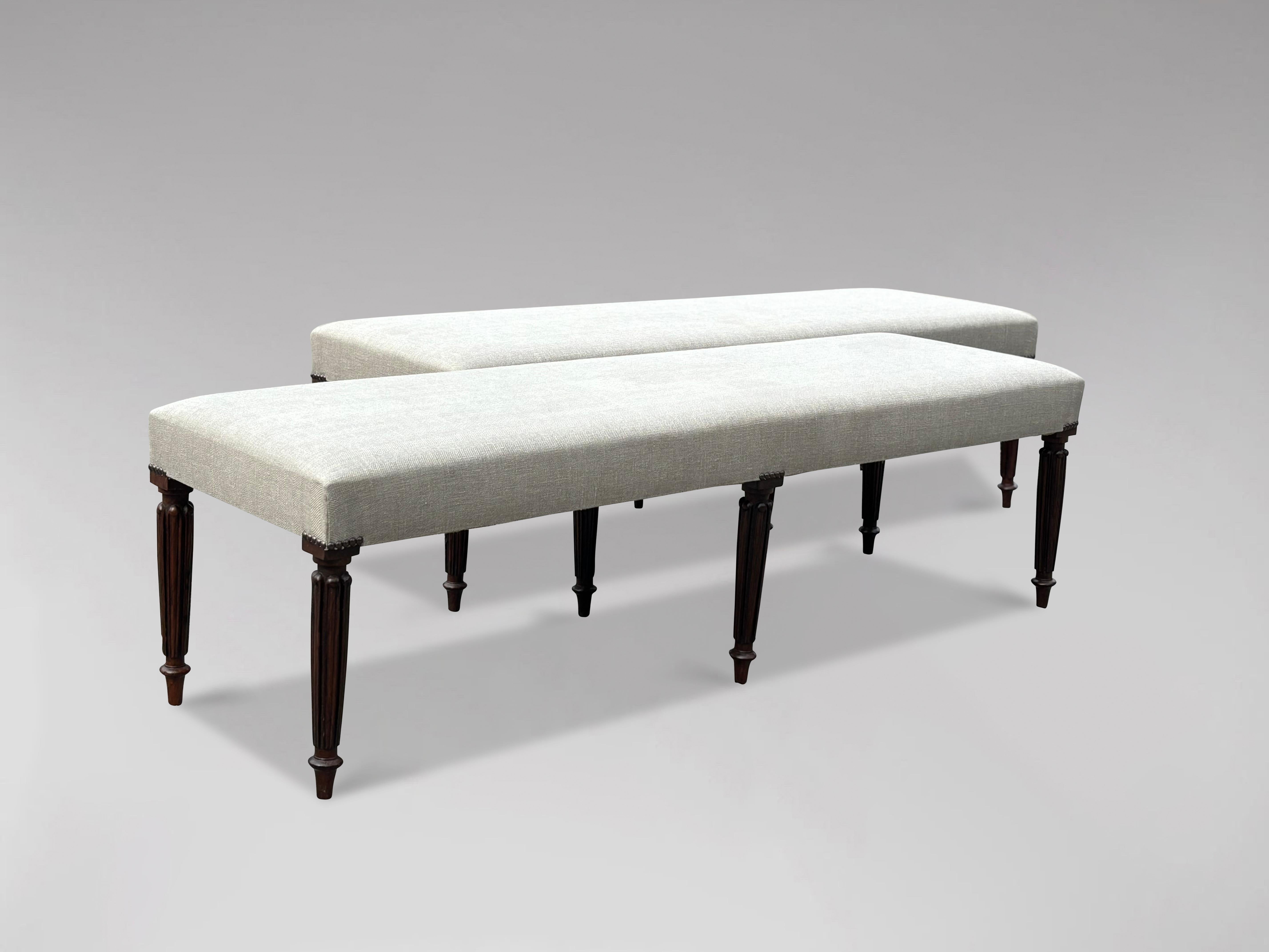 A pair of lovely proportioned 19th century window seats. Rectangular newly reupholstered seat and hand tacked around the legs. The whole raised on six turned and fluted tapering legs. The upholstery is perfect and it’s all very sturdy. These window