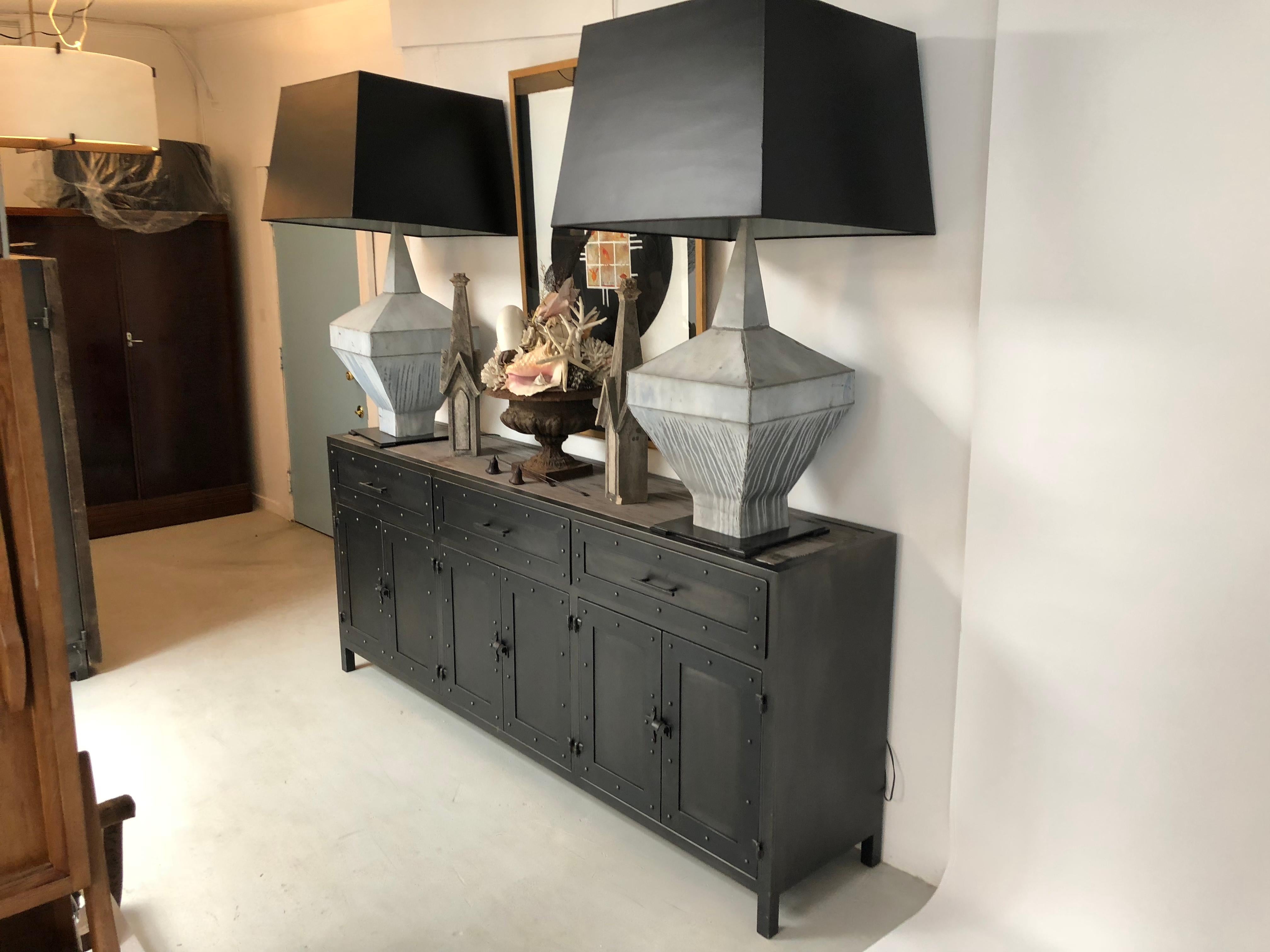 Two large scale table lamps. Can also work as a floor lamp. Created from a pair of matching zinc roof finial from a French chateau which had to replace its roof. These architectural pieces have been mounted on a steel base with a black enamel