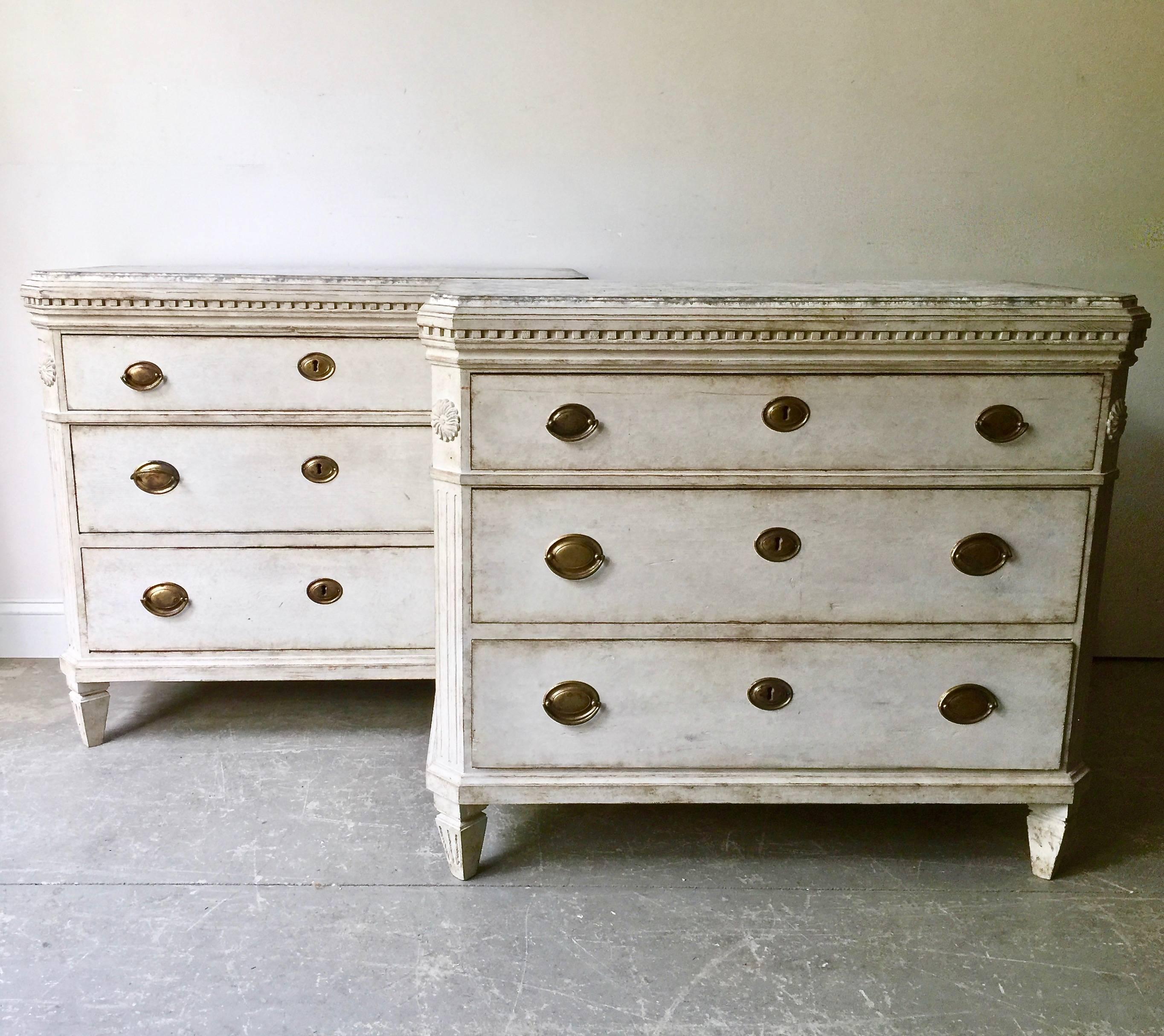 A very fine pair of 19th century, Swedish Gustavian style chest of drawers with very handsome original hardware and exceptional floral carvings on each reeded corner posts under the marblesized wood shaped top. A truly special pair of chest, Sweden,