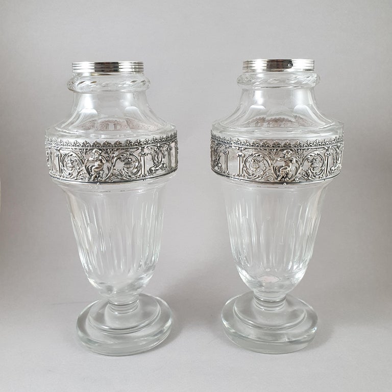 Pair of 19th French sterling silver and crystal vases 

Decorated with cherubs, fish, foliage and flower. 

Hallmarked Minerva 1st title for 950/1000 purity silver

Height 22 cm

Great condition