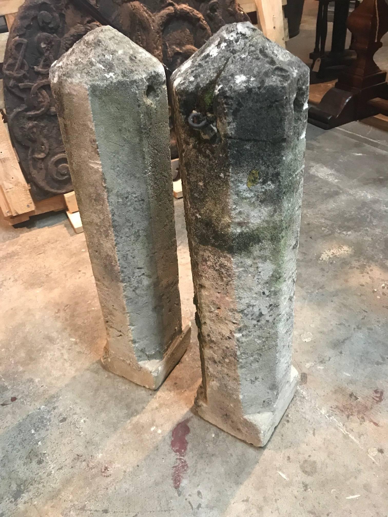 A handsome and primitive pair of carved stone markers of obelisk shape. Wonderful as garden ornaments or as an interior accent.