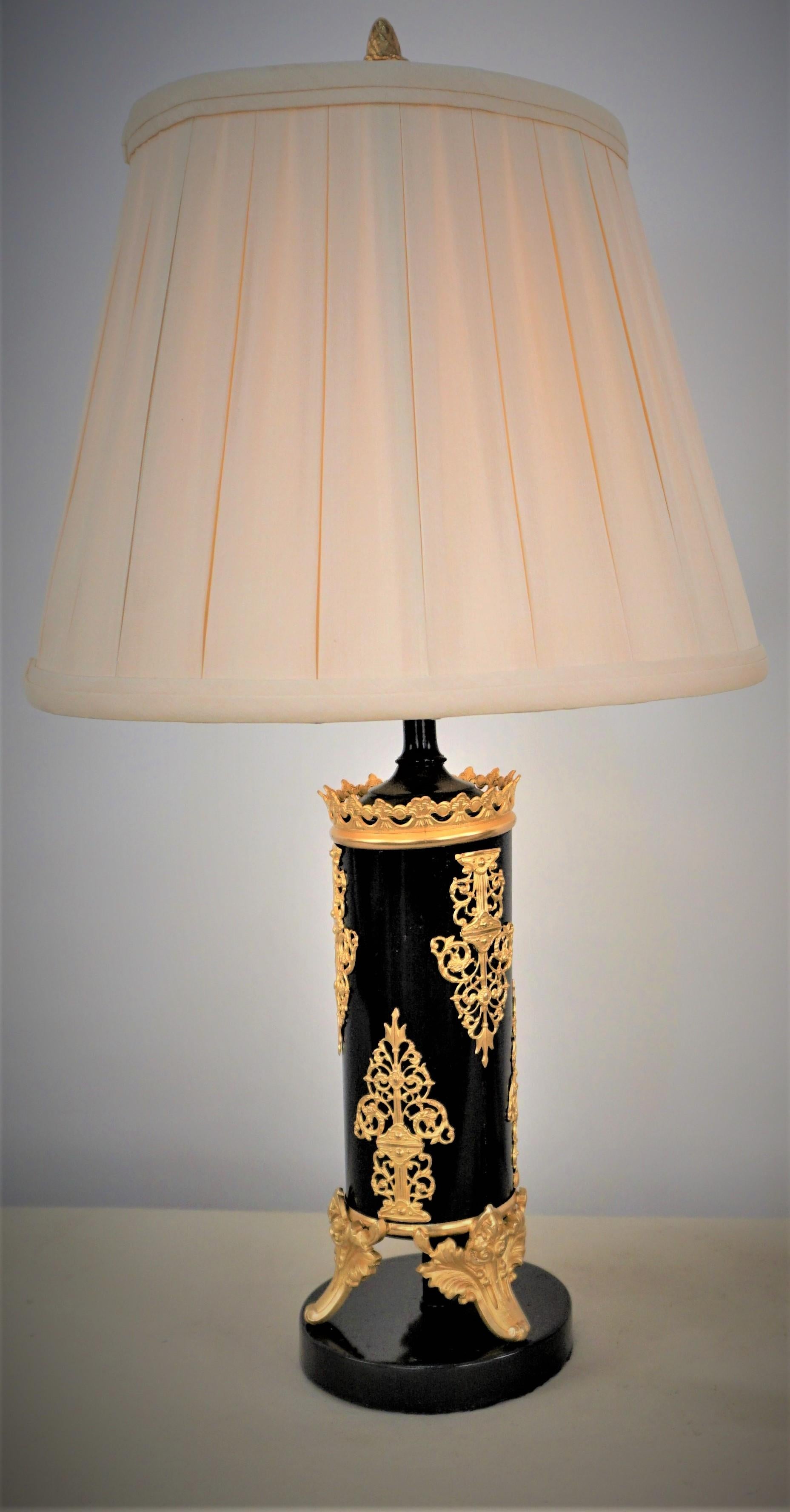 Pair of 19th century gilt bronze over black table lamp fitted with silk box pleat lampshades.
Professionally rewired.